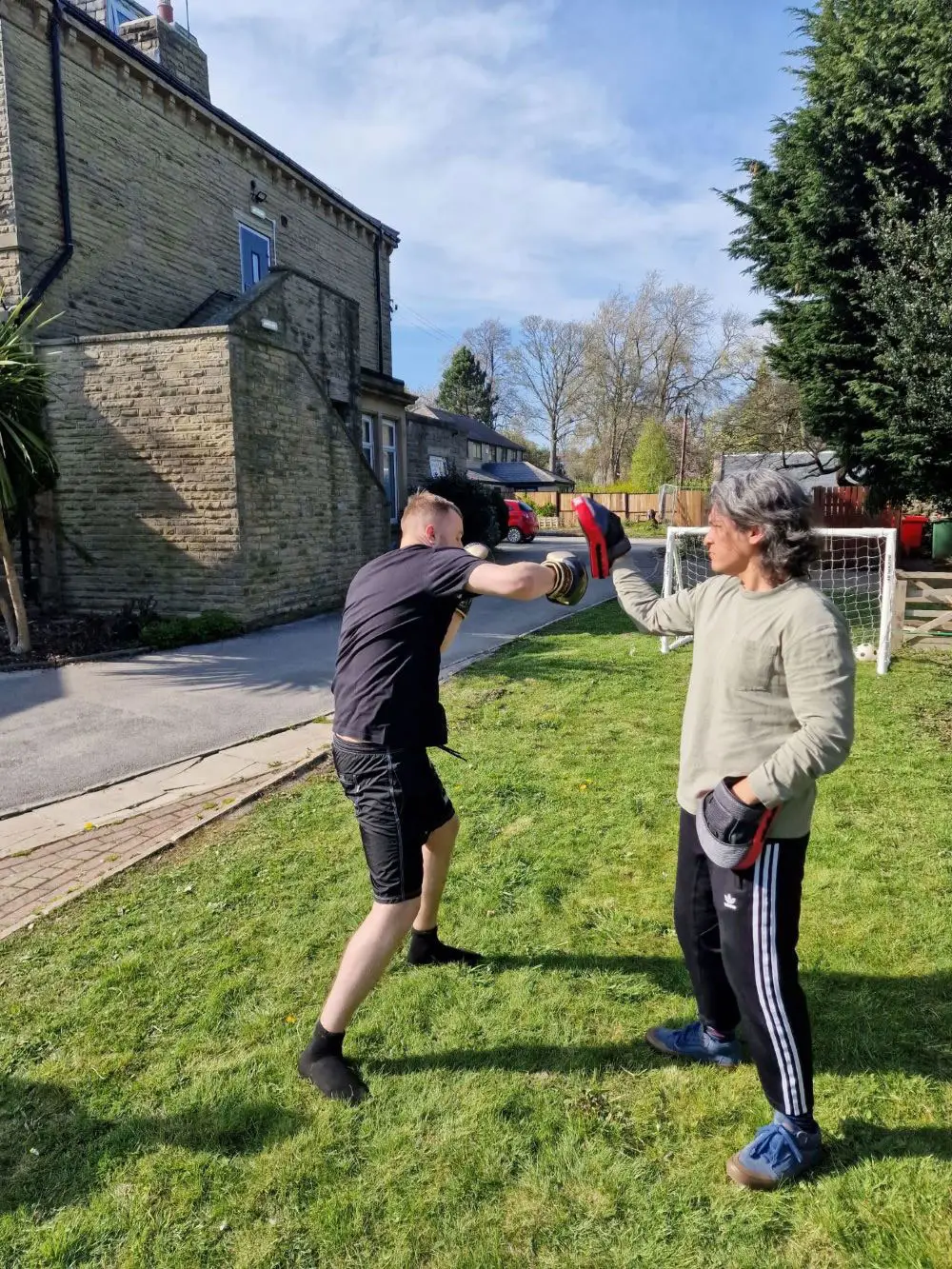two residents boxing outdoors
