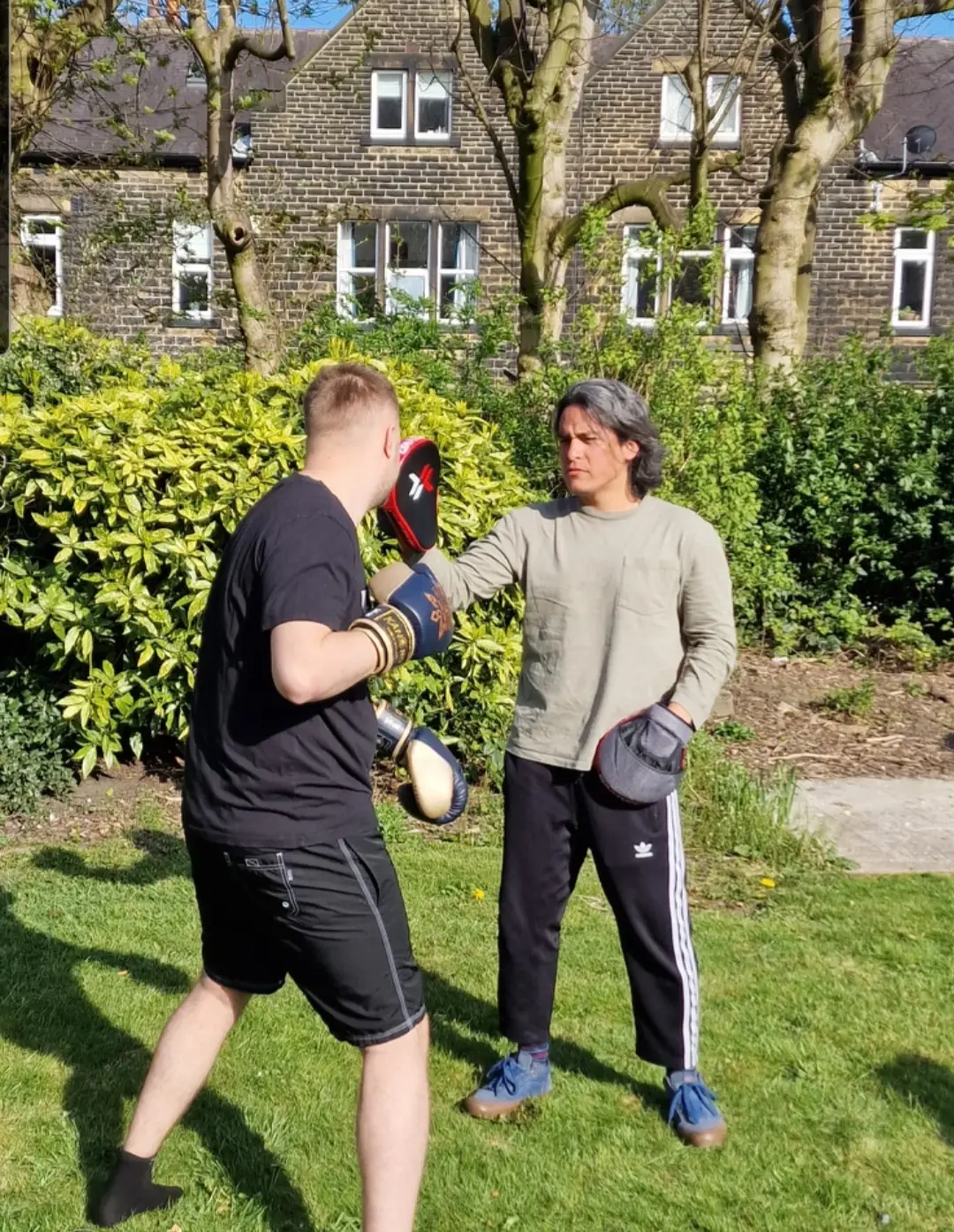 two residents boxing outdoors