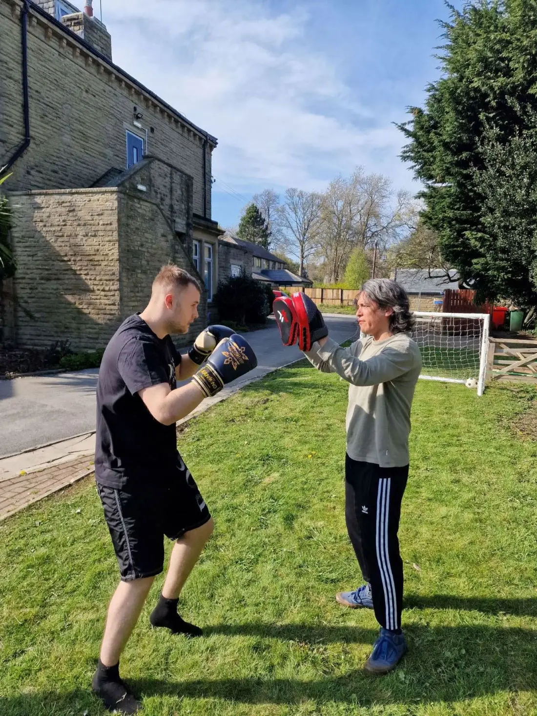 two residents boxing outdoors