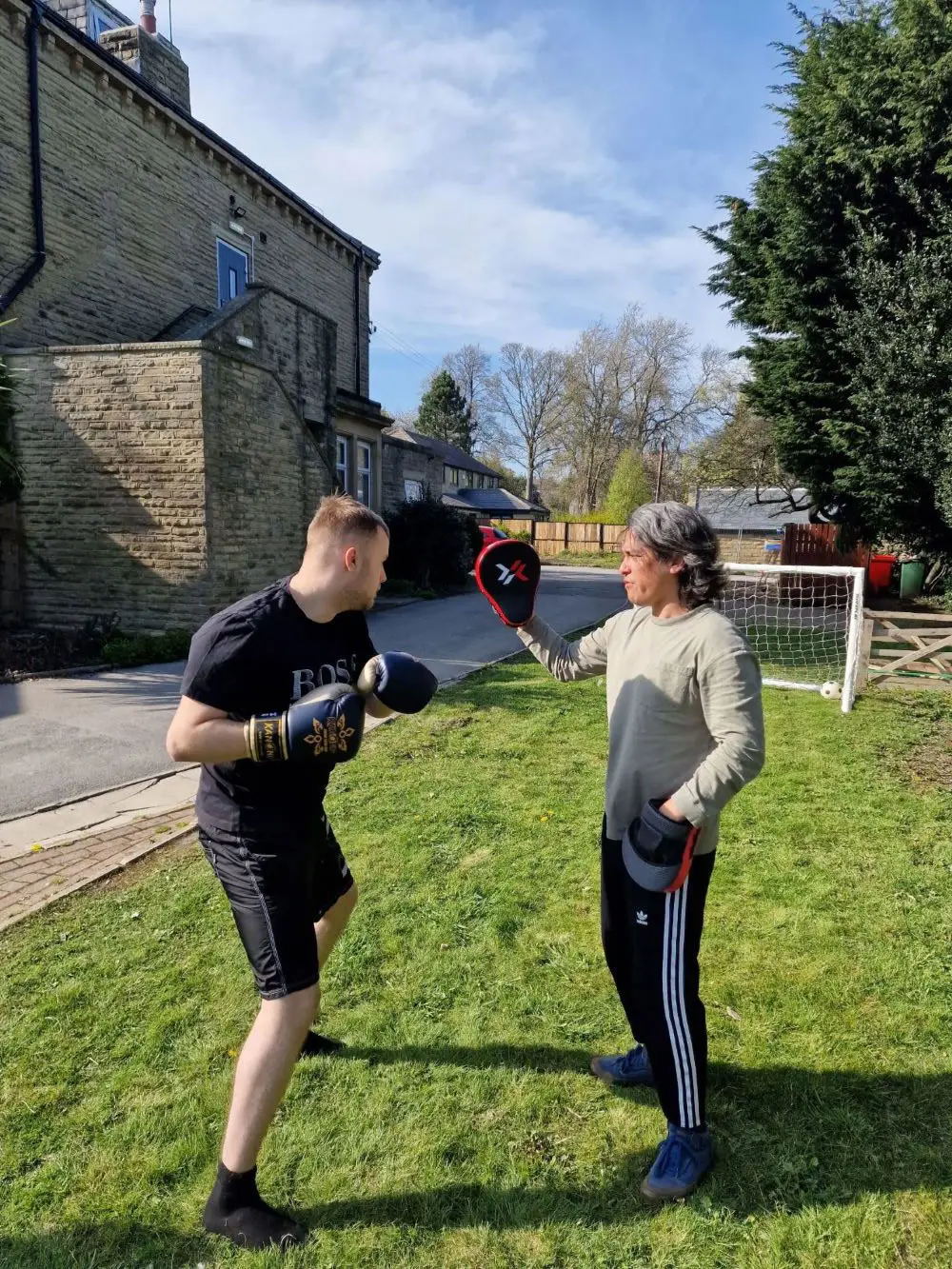 two residents boxing outdoors