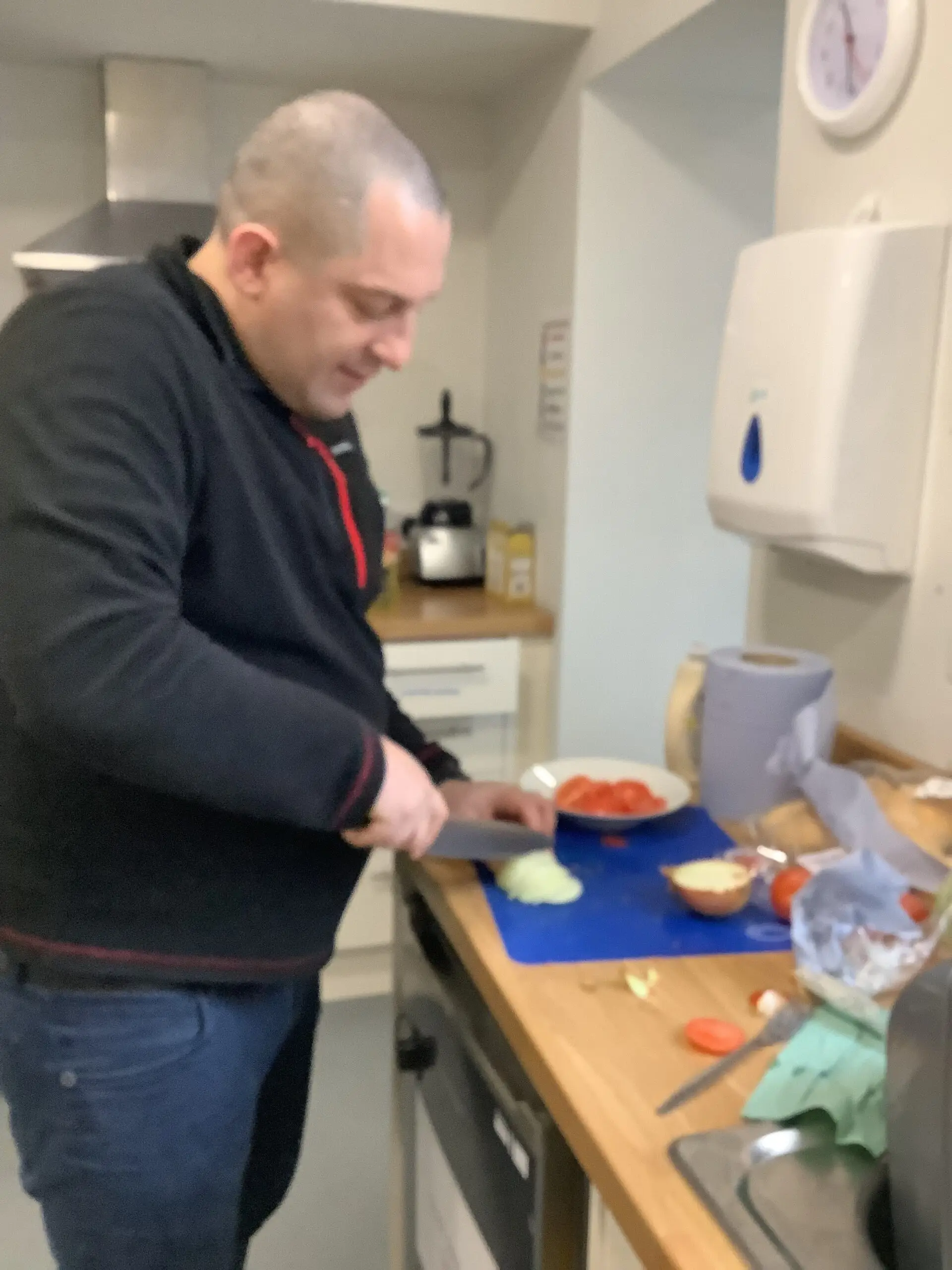 resident chopping onions and tomatoes