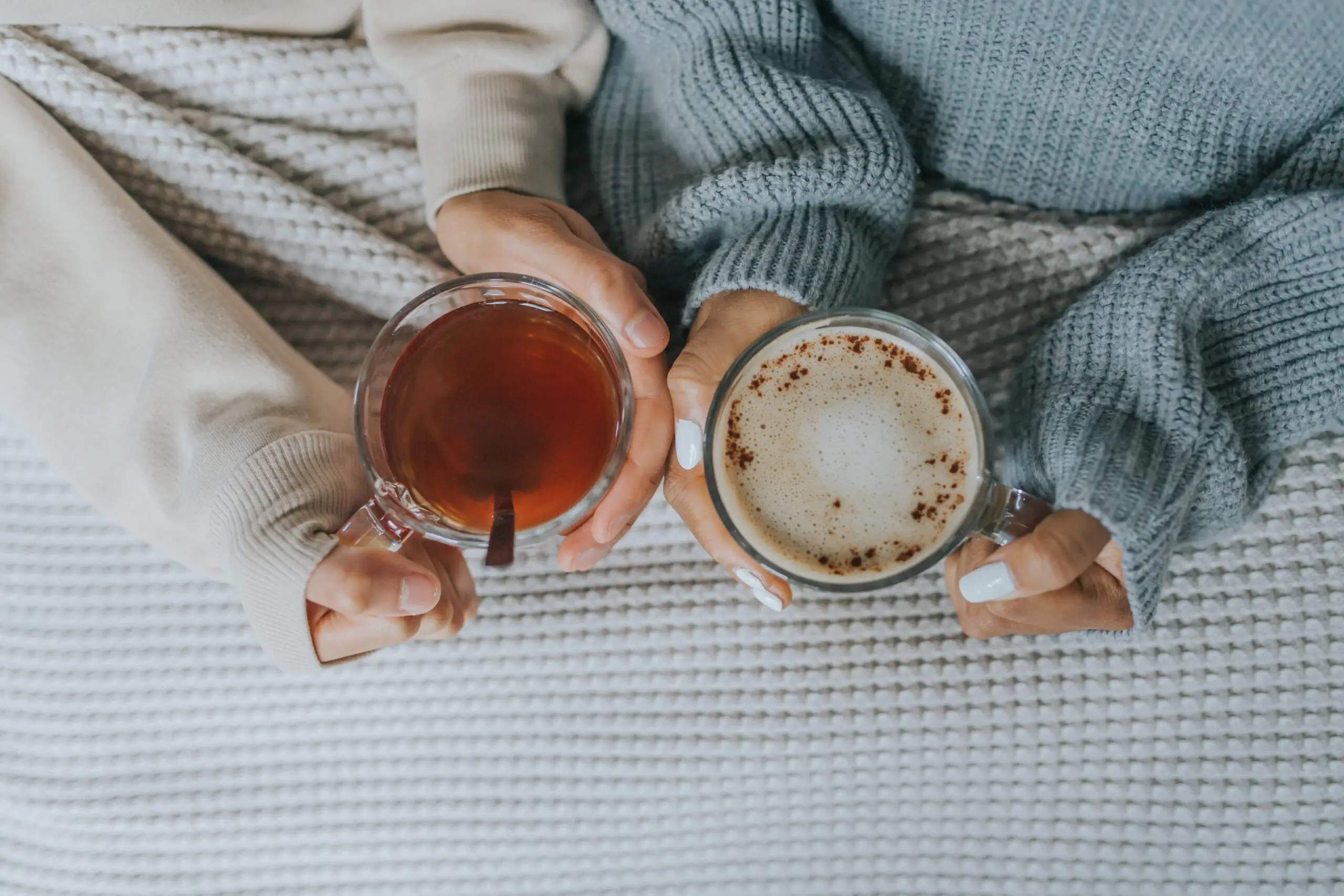 providing support: 2 people holding a cup of hot drink