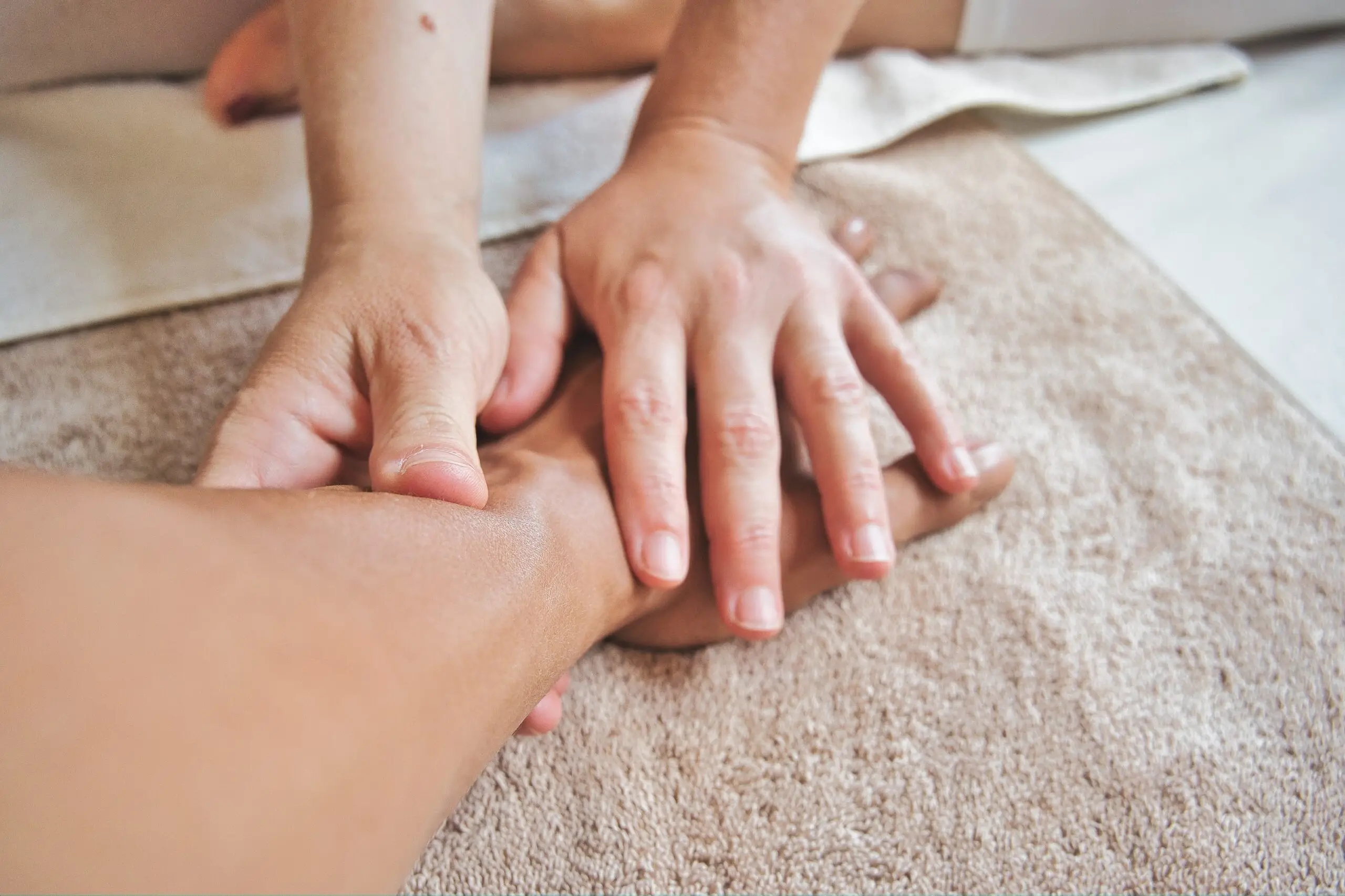 two hands holding an arm