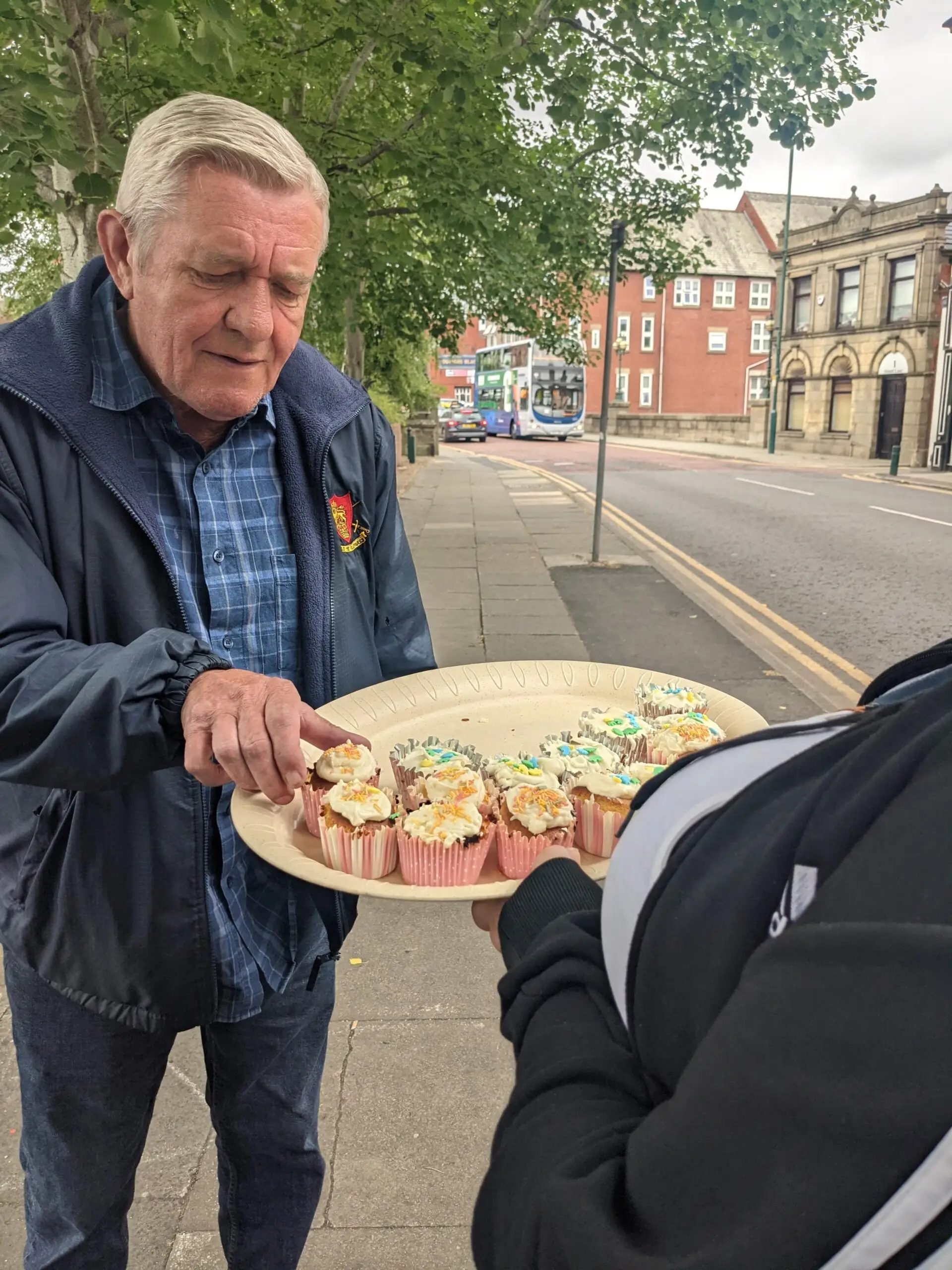 resident handing out cupcakes