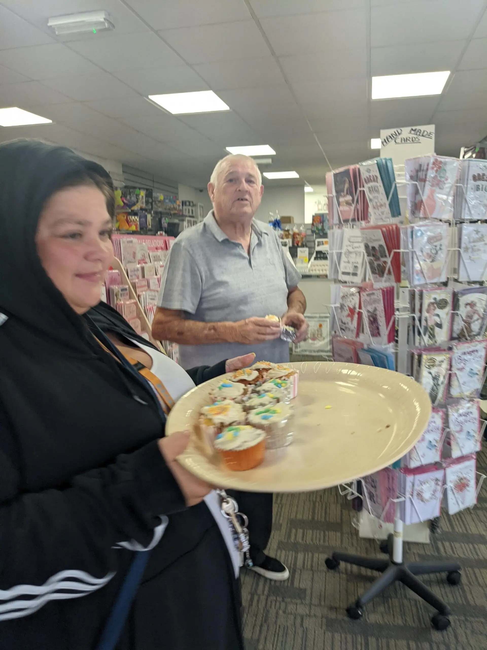 residents handing out cupcakes