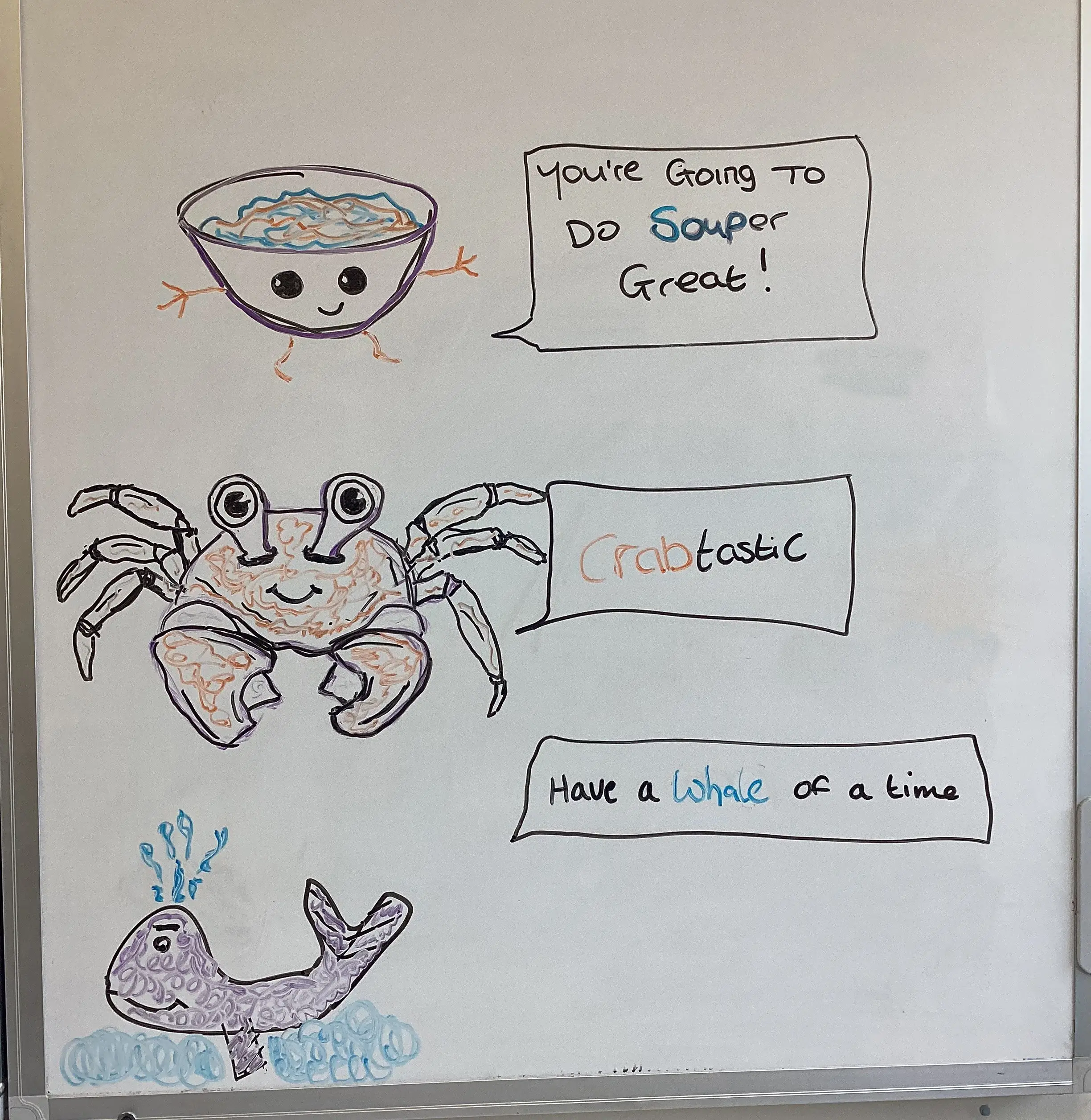 whiteboard with drawings of bowl of soup, crab and whale, and positive quote written next to the drawings