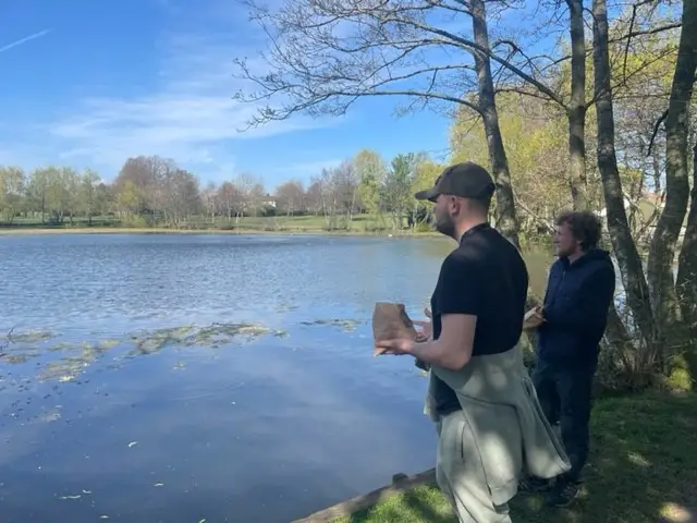 2 residents feeding the ducks