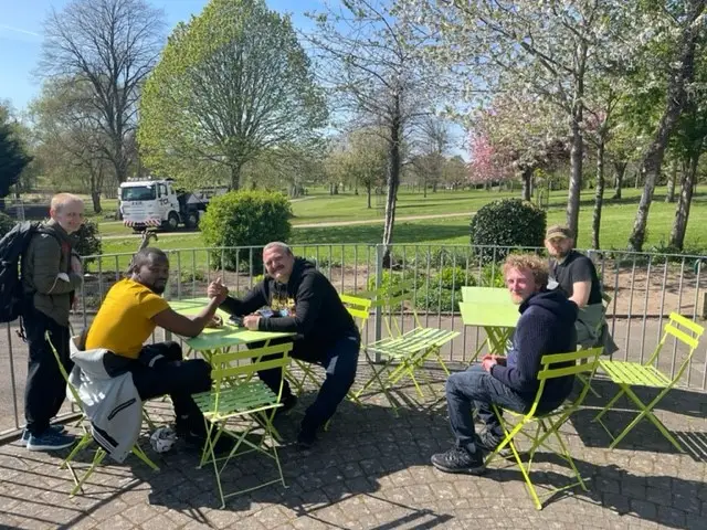residents sitting on green garden furniture