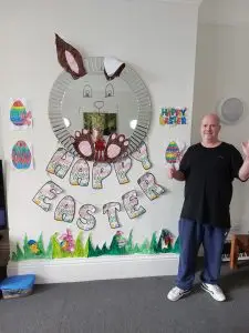 happy easter bunding under mirror with bunny ears and paws