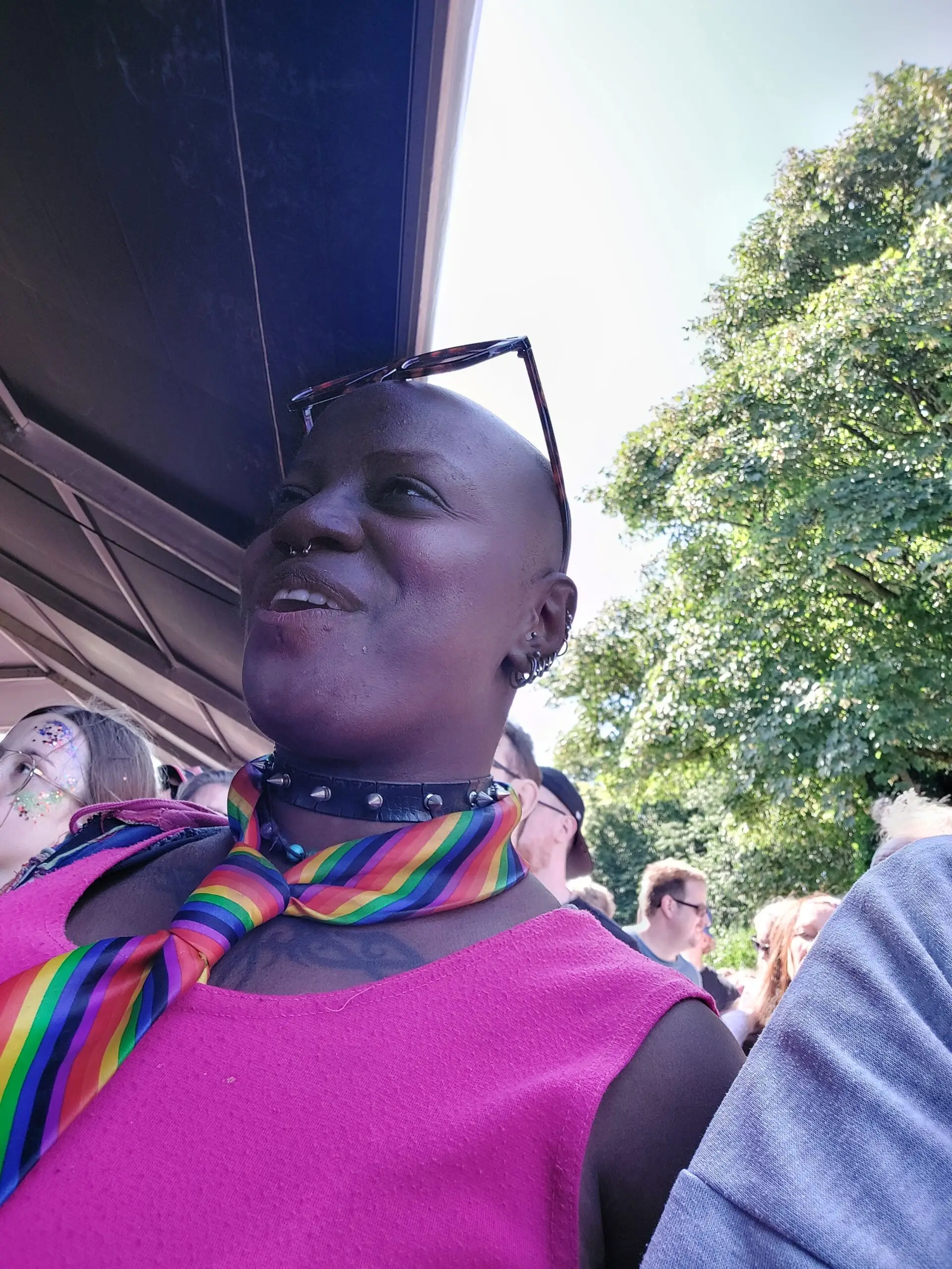 resident in pink top and rainbow scarf at festival