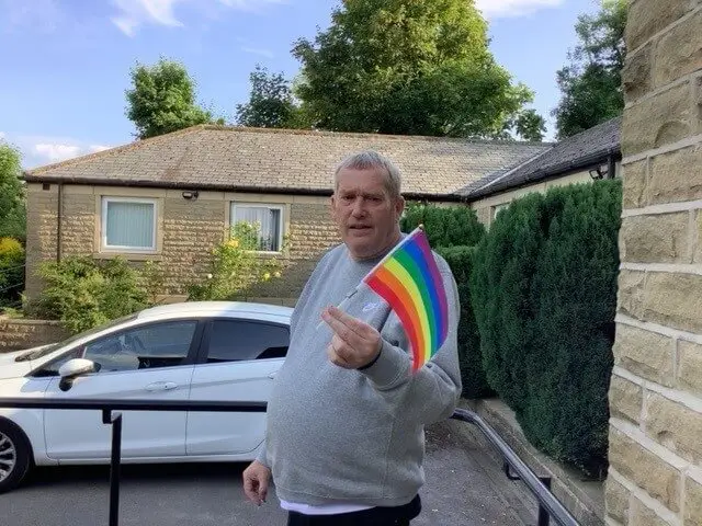 Gentleman waving Pride Flag