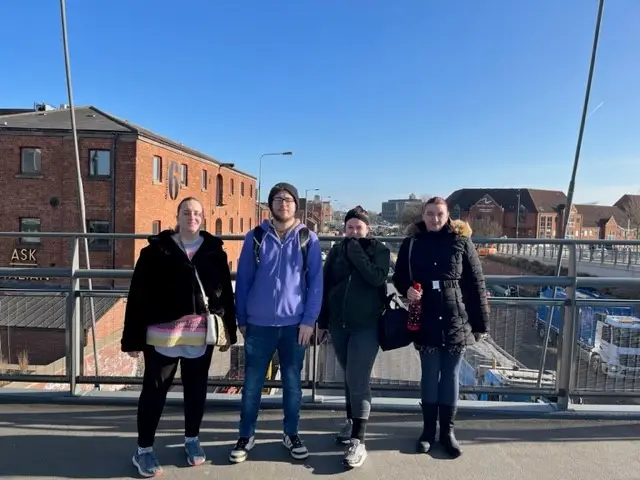 Four residents on a bridge