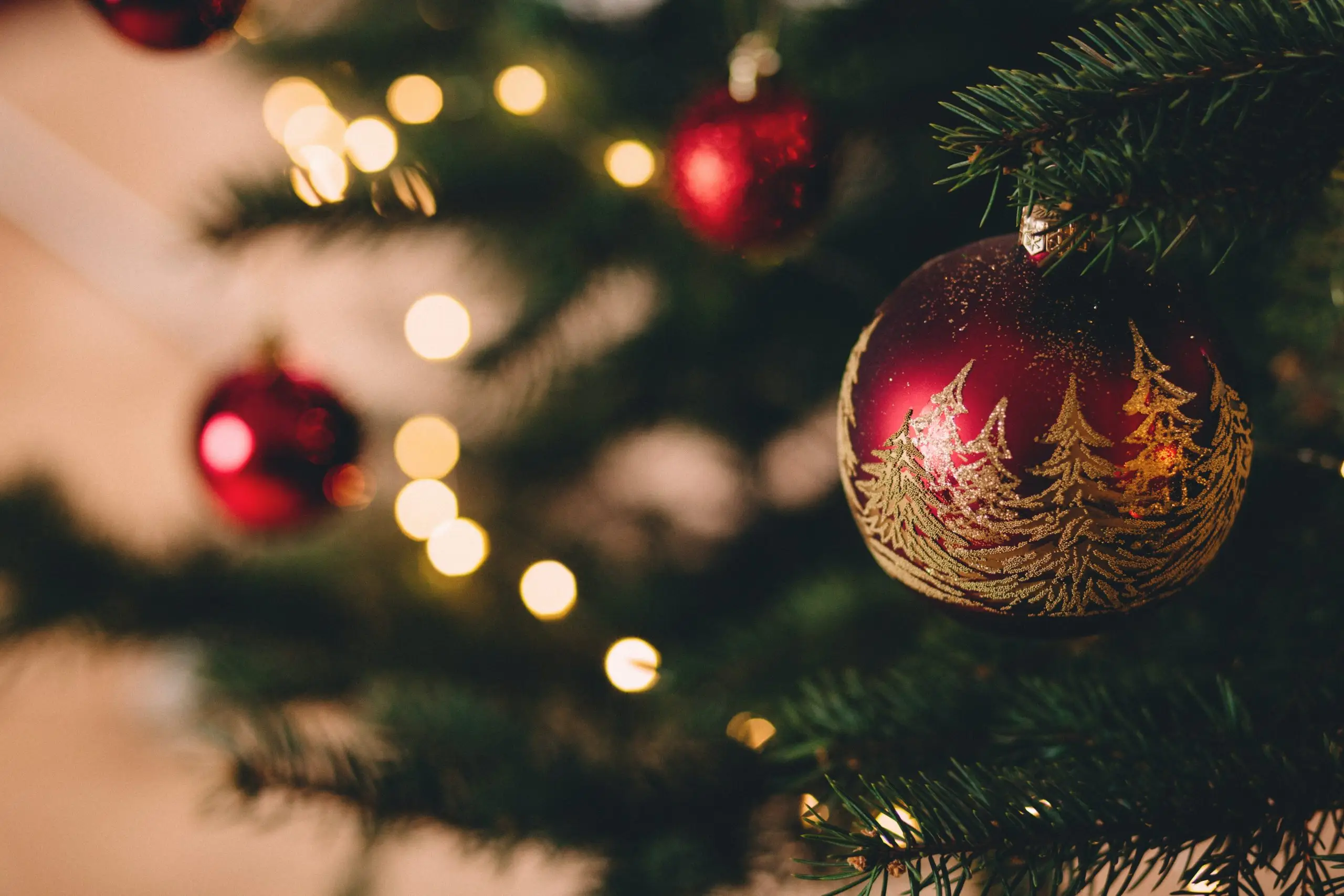 red christmas bauble with golden trees
