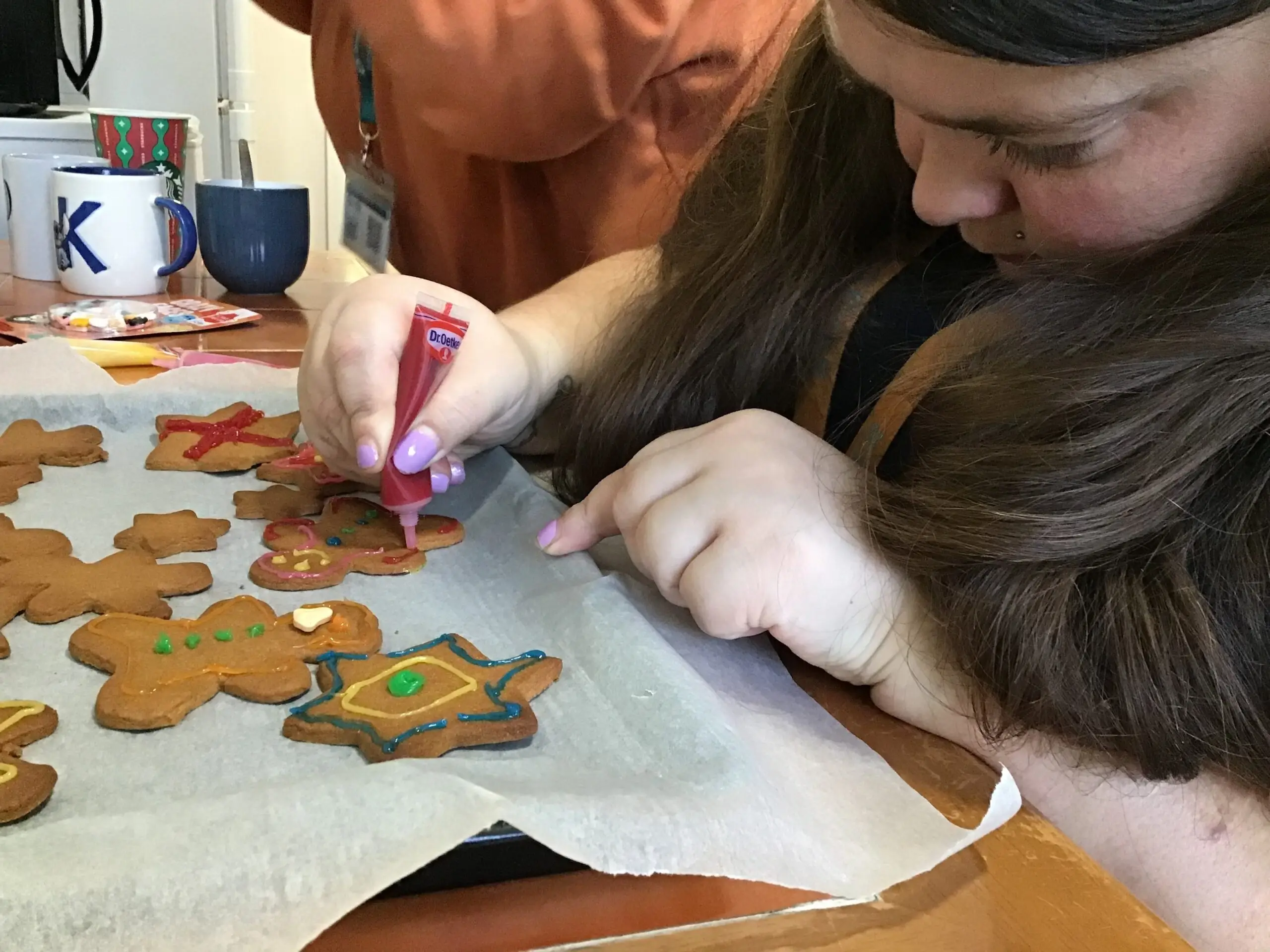 resident decorating gingerbread with icing