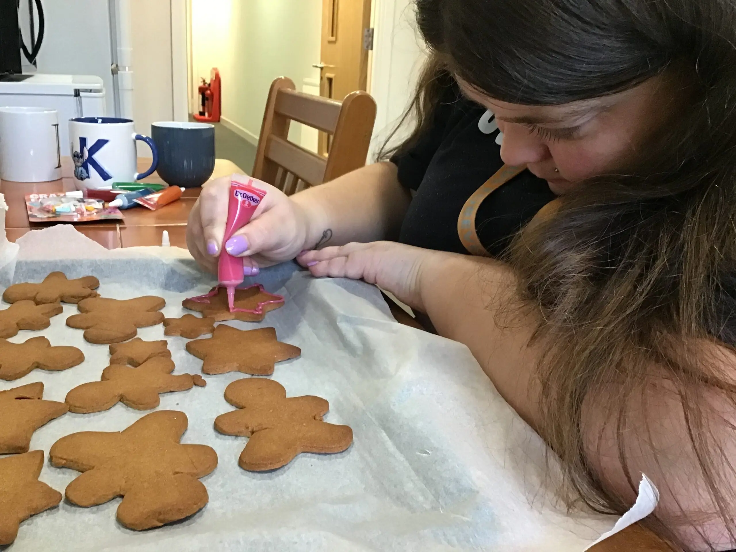 resident decorating gingerbread with icing