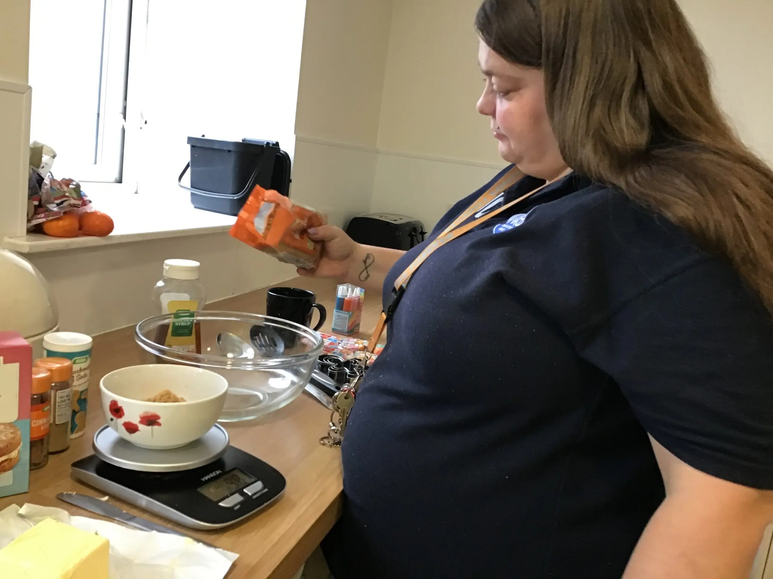 resident pouring ingredients into a bowl