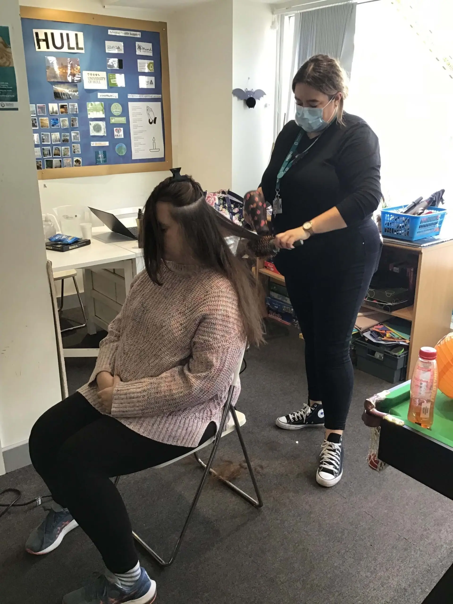 Team member styling residents hair