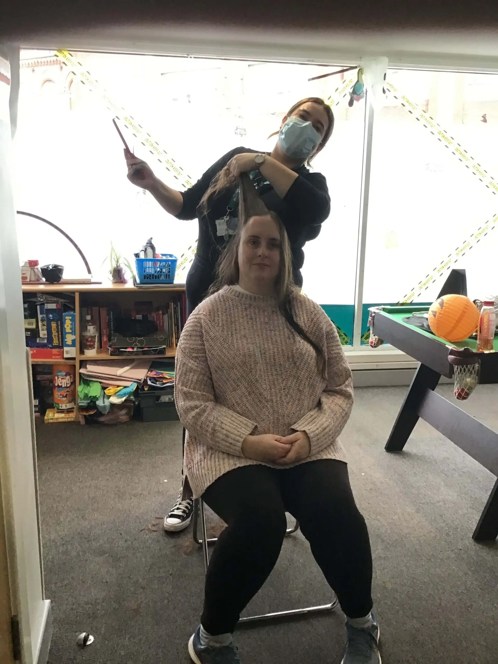 resident getting her hair cut by team member