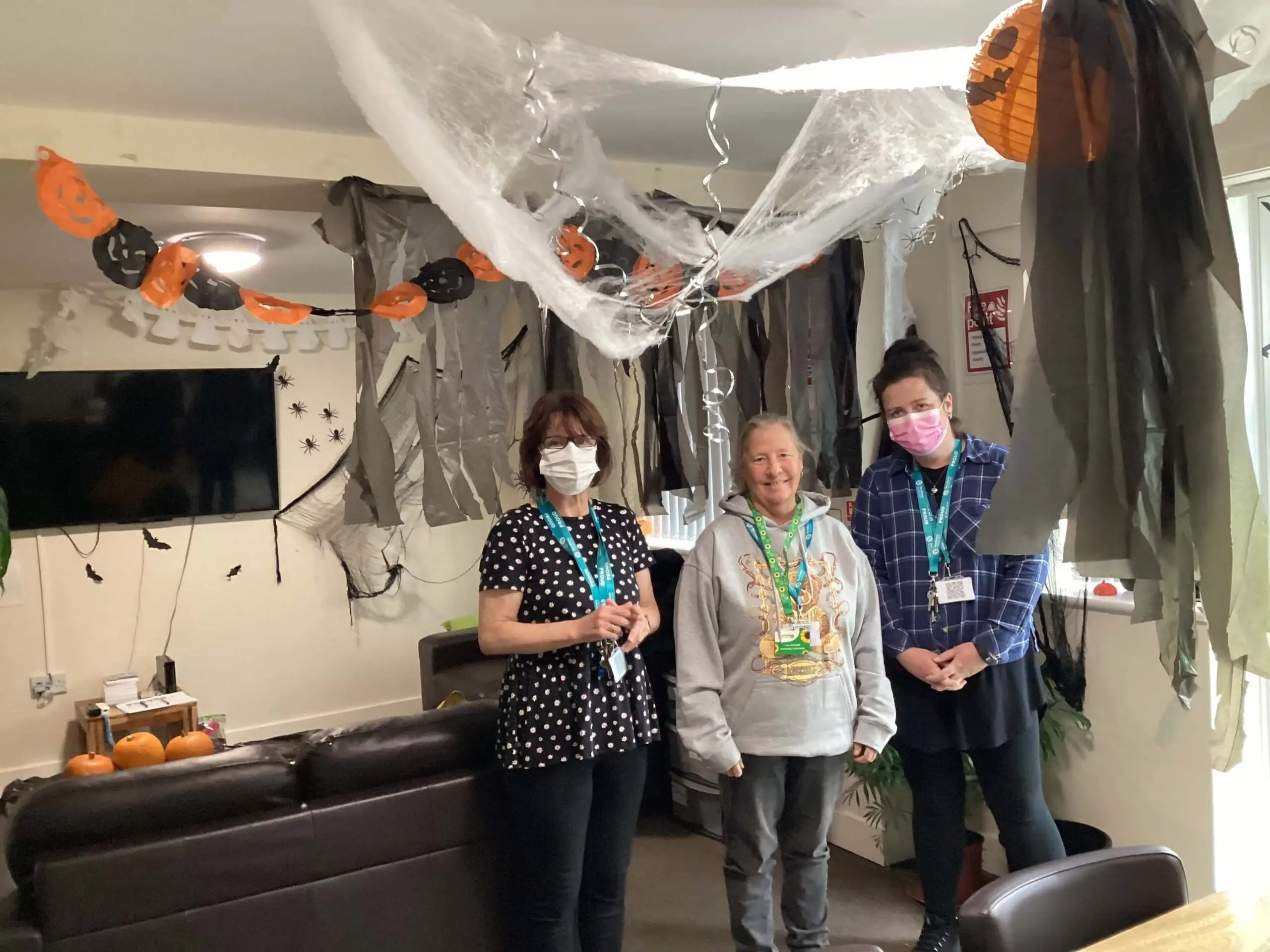 Resident and team member proudly displaying their Halloween decorations