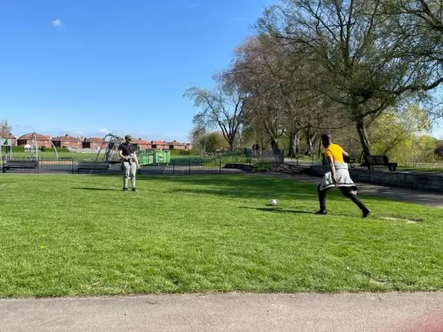 2 residents playing football together