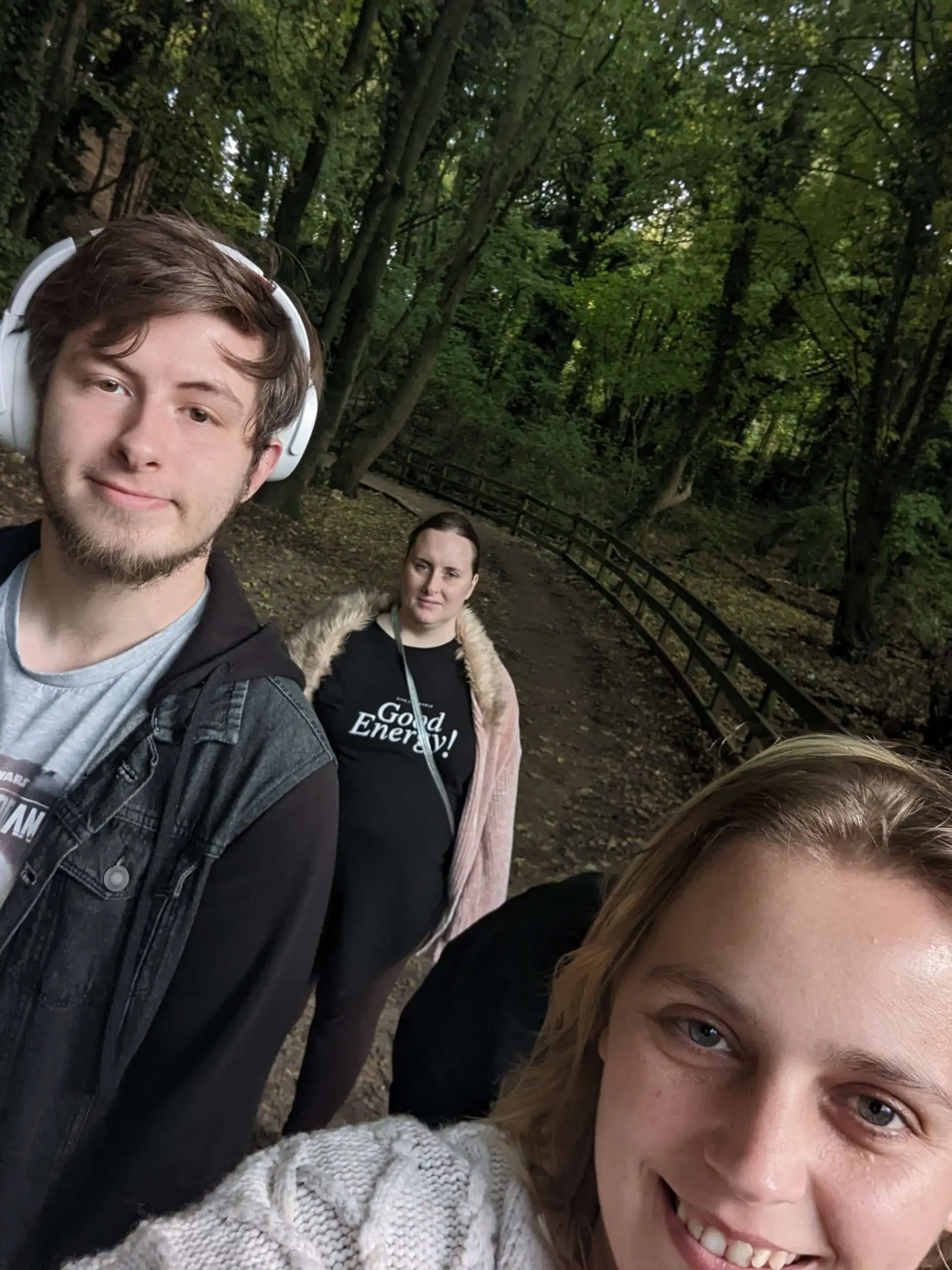 three people walking through the park