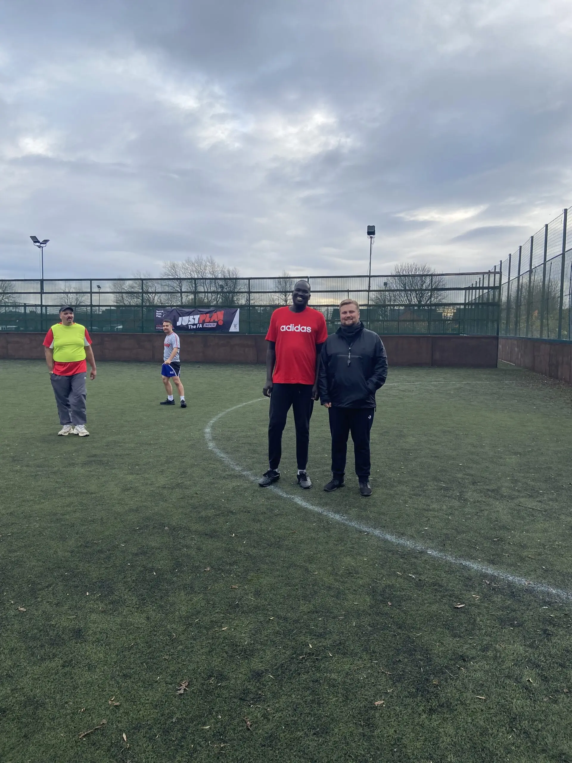 resident and director on football pitch