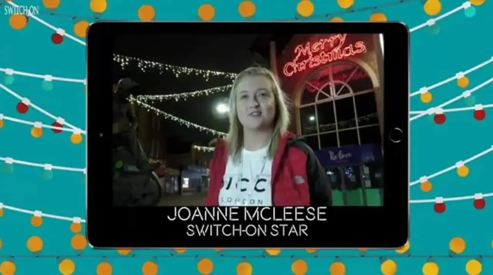 team member at christmas lights switch on