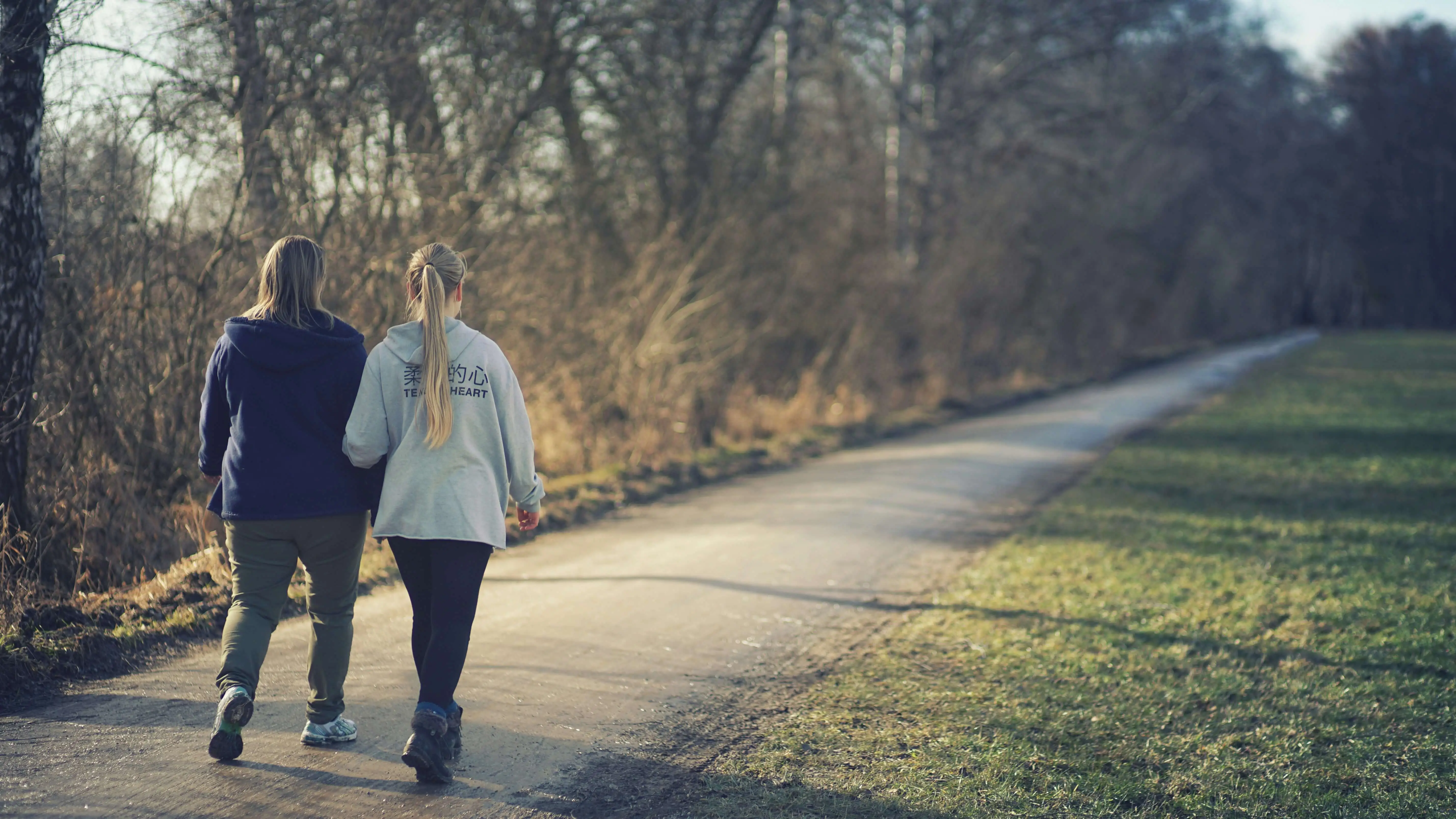 Resident and support worker walking down countryside path relating to the health and social care sector and the 2025 Spending Review