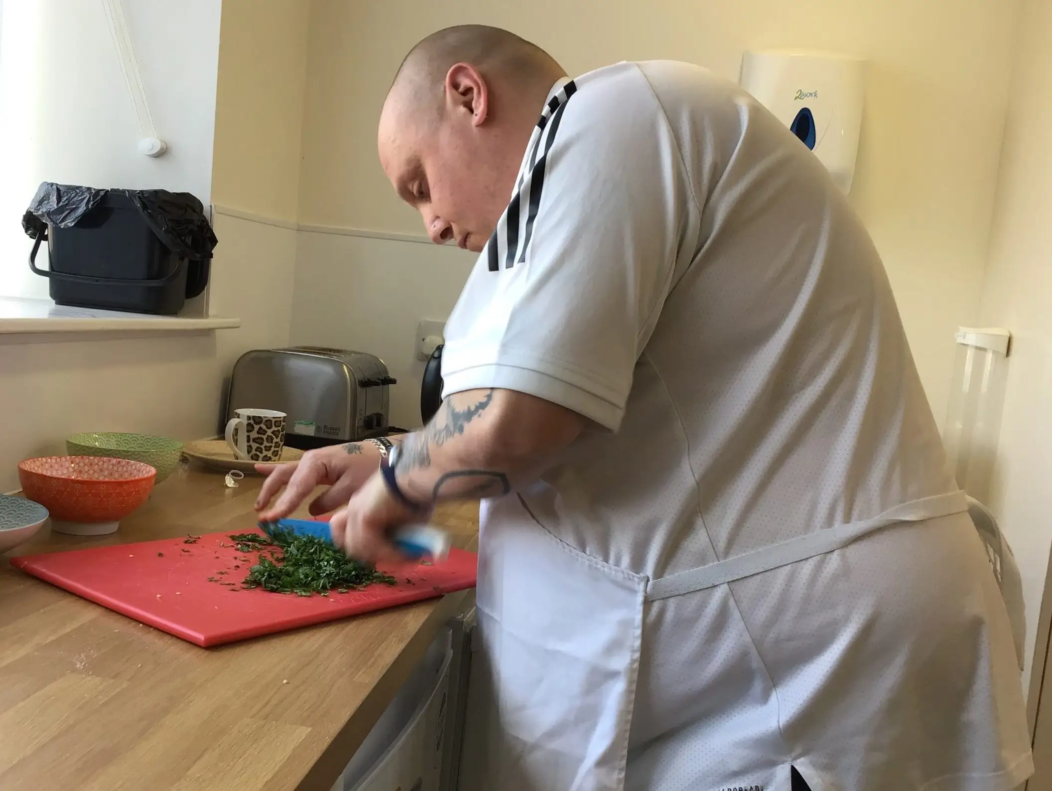 male resident chopping vegetables