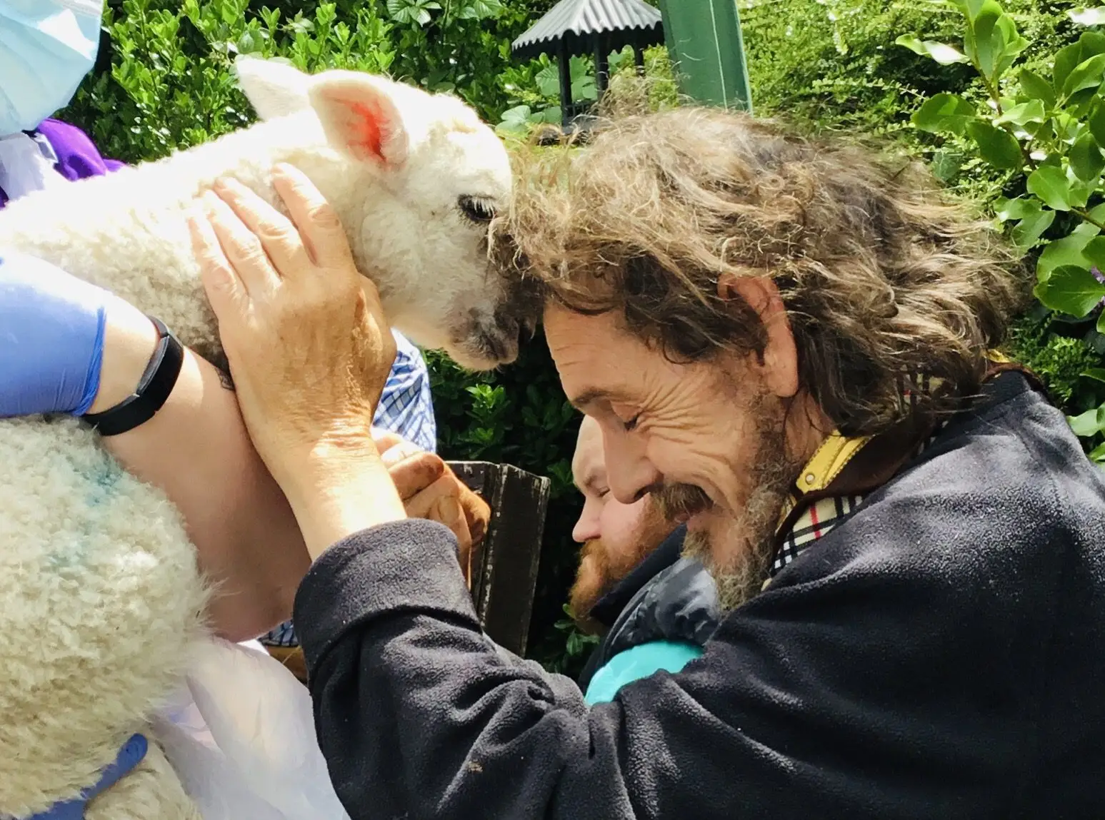 resident touching foreheads with a lamb