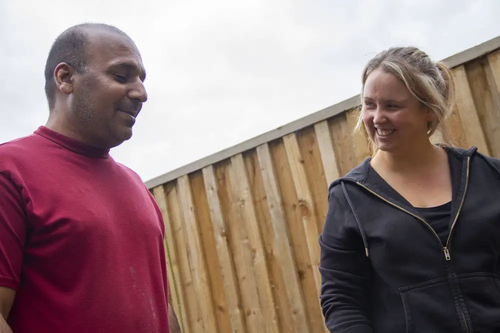 resident and team member smiling at each other in garden