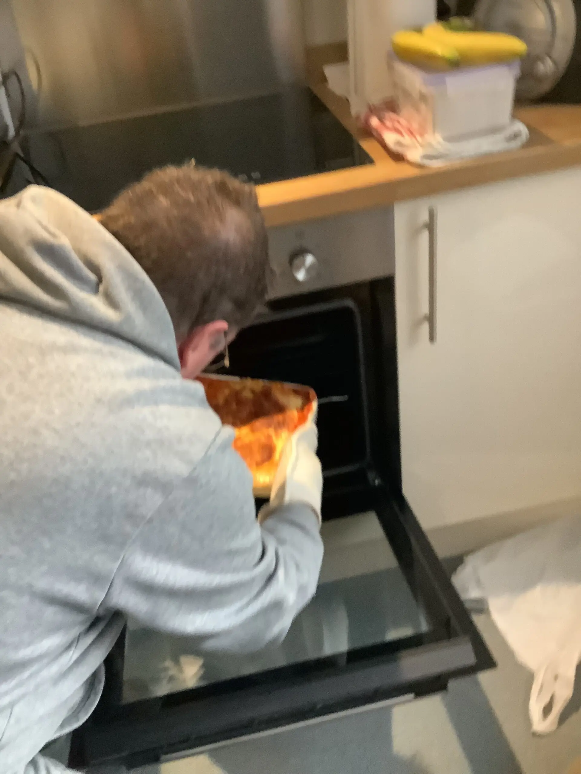 resident putting homemade lasagne in the oven
