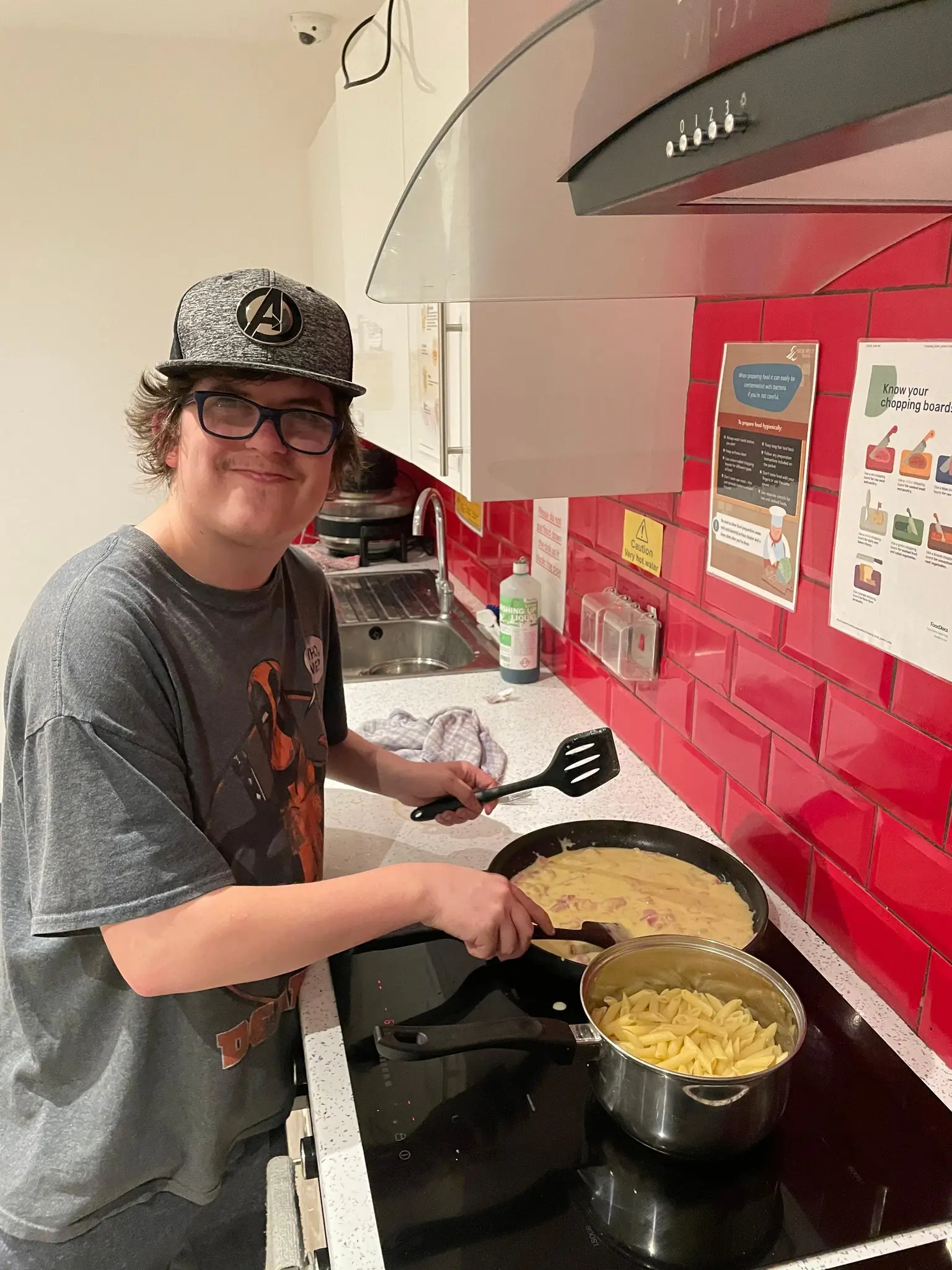 Male resident making mac and cheese