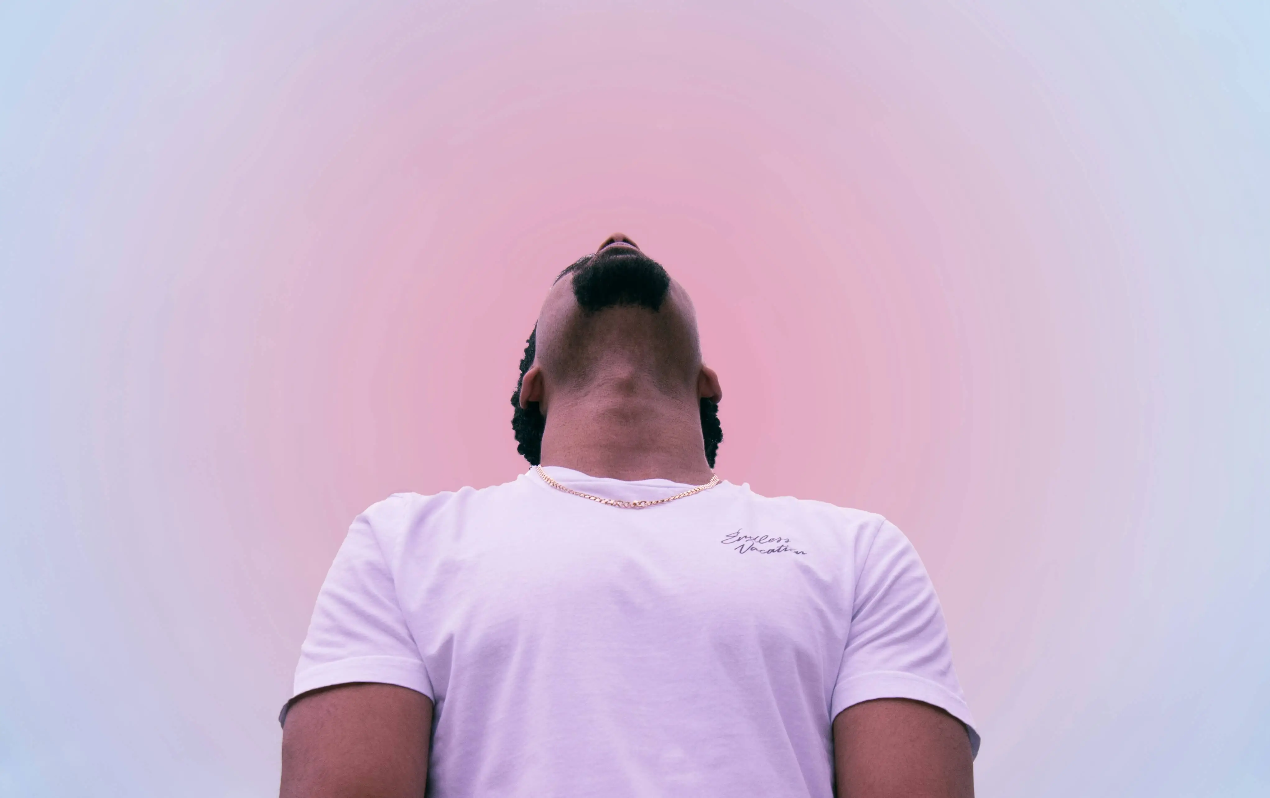 Man looking into a soft pink sky to represent bipolar disorder and it's effects on the brain.