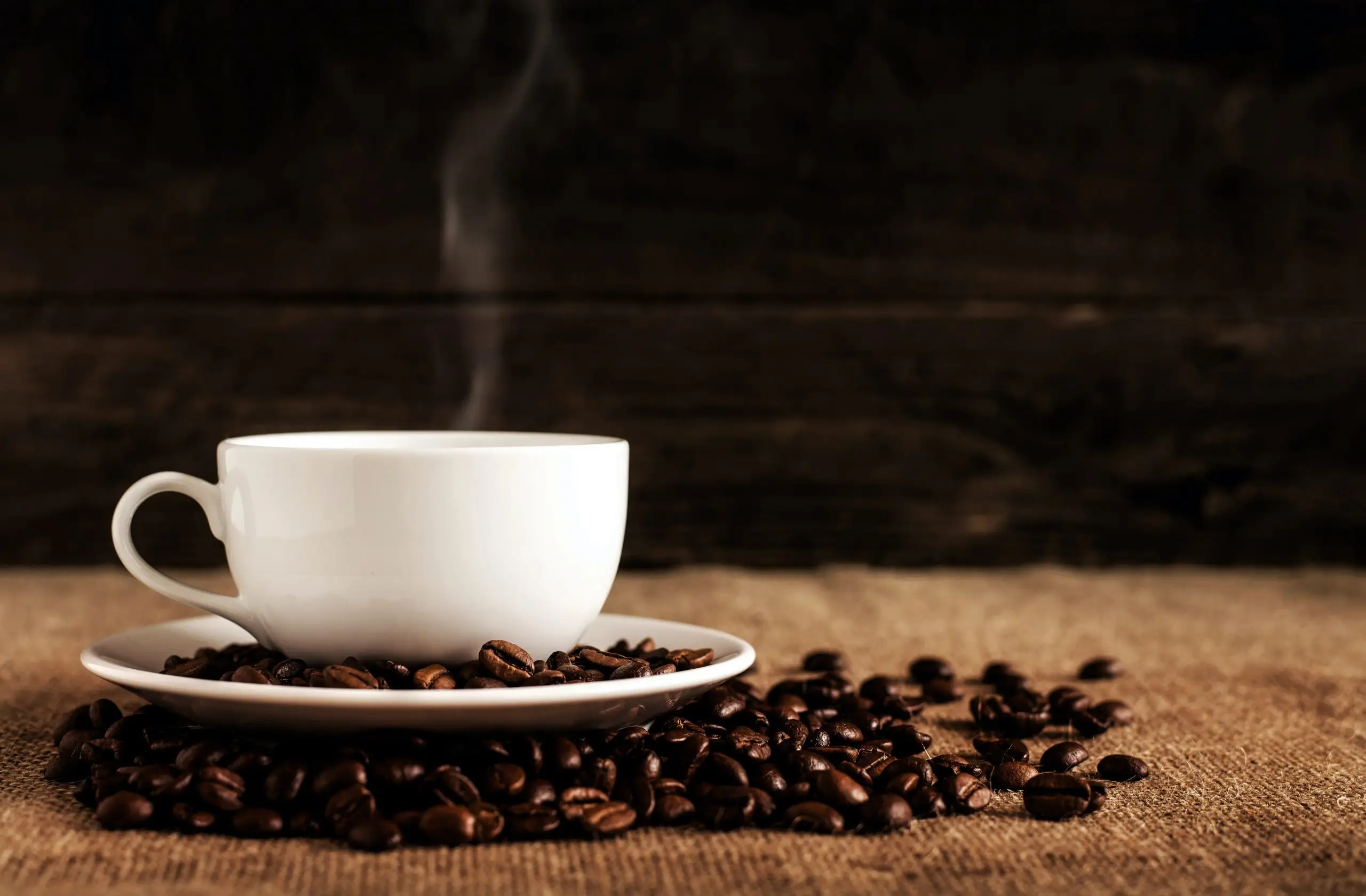 coffee cup with plate of coffee beans