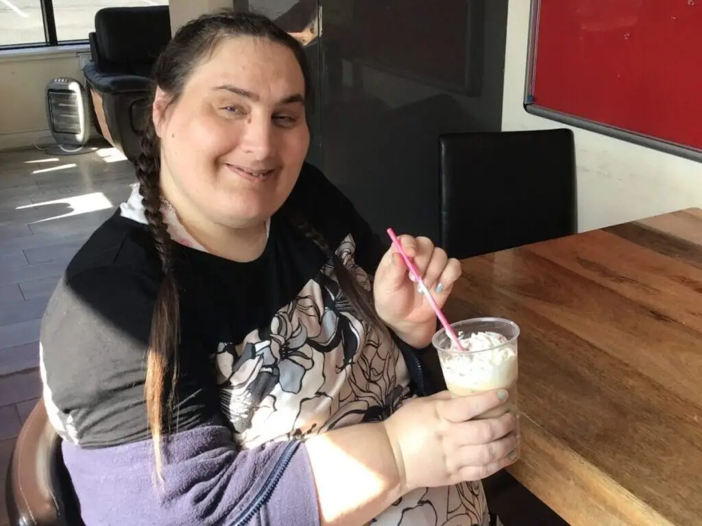 female resident enjoying milkshake