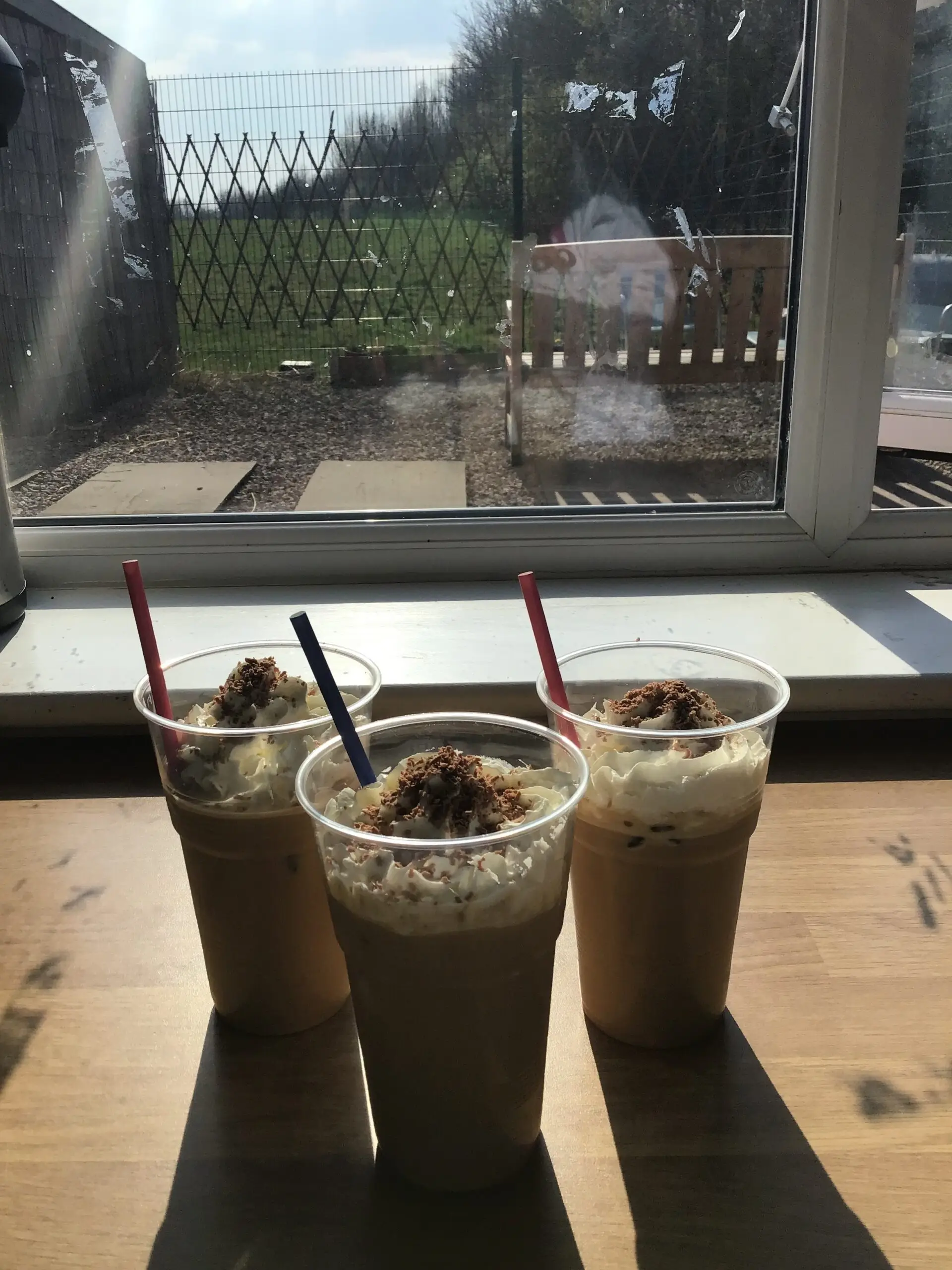 milkshakes and ice coffee on windowsill