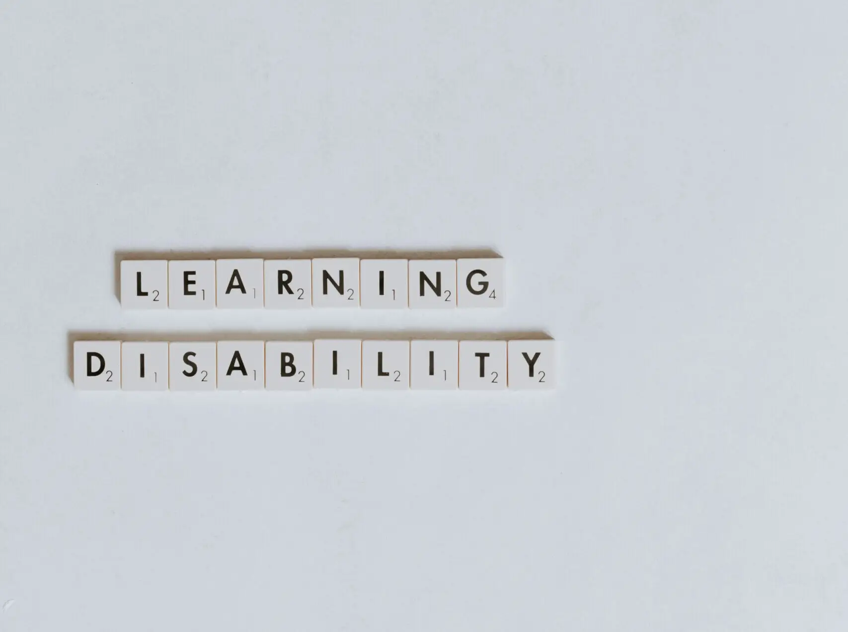 white letter tiles spelling "learning disability"