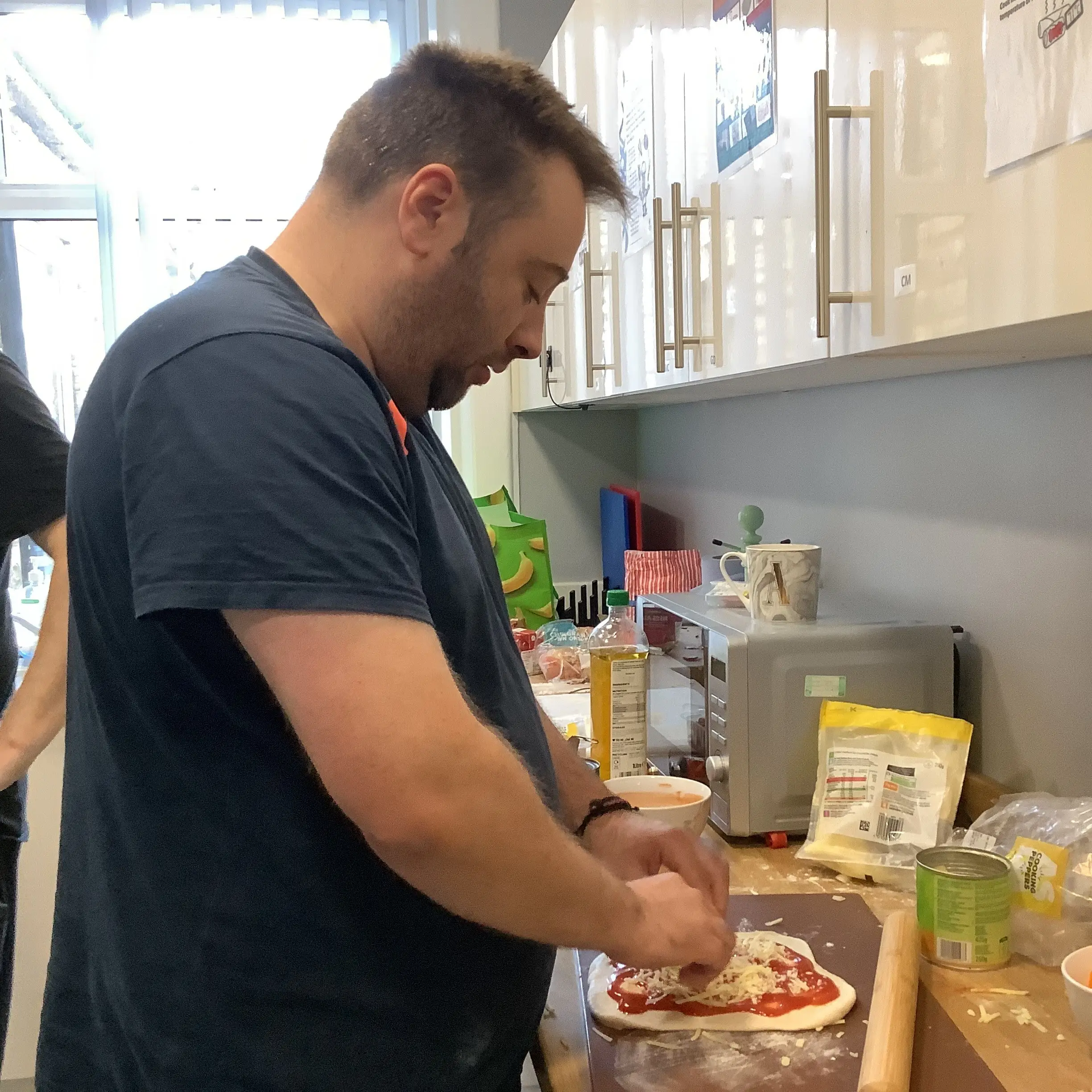 male resident making pizza