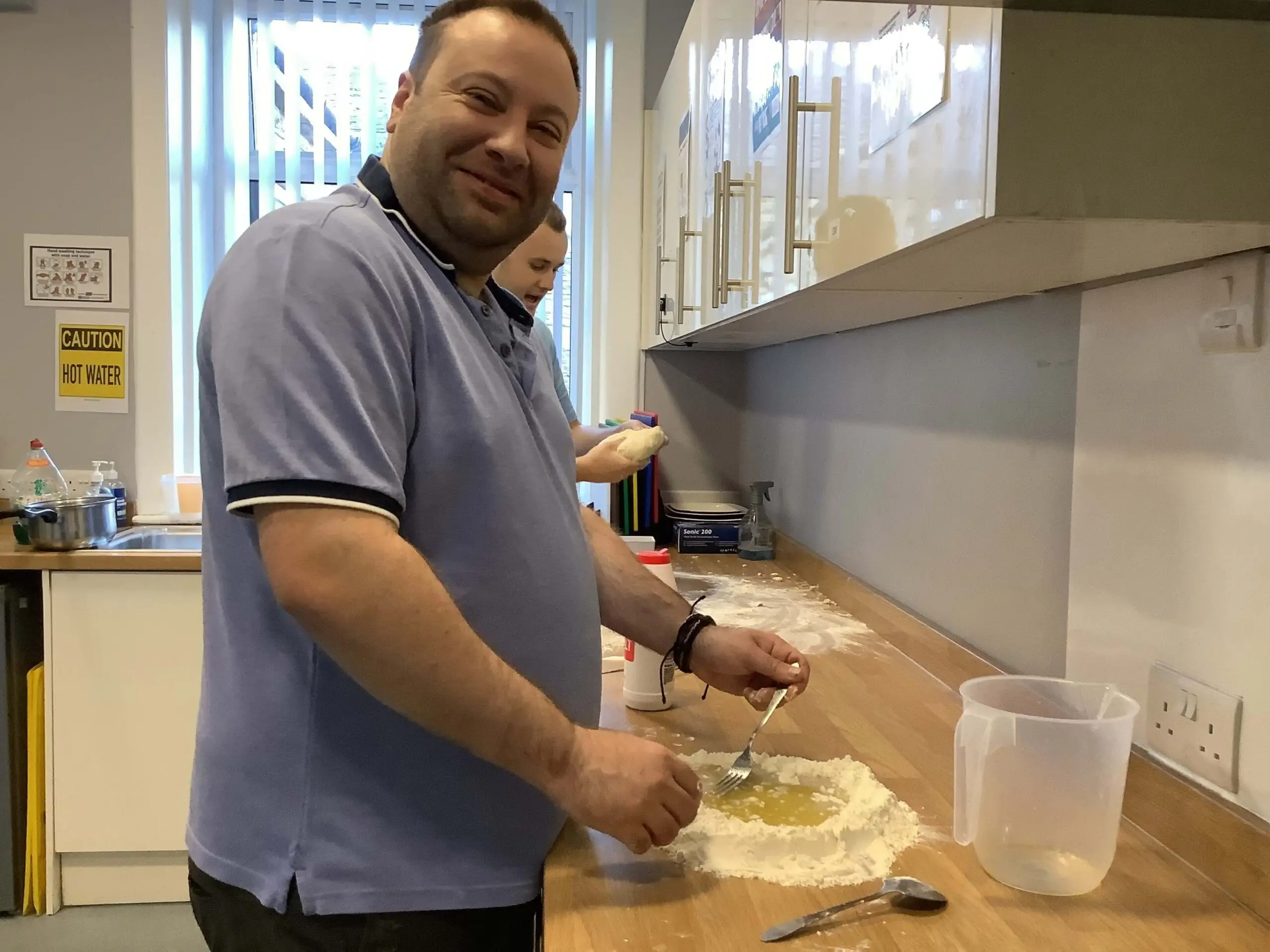 resident making pizza dough