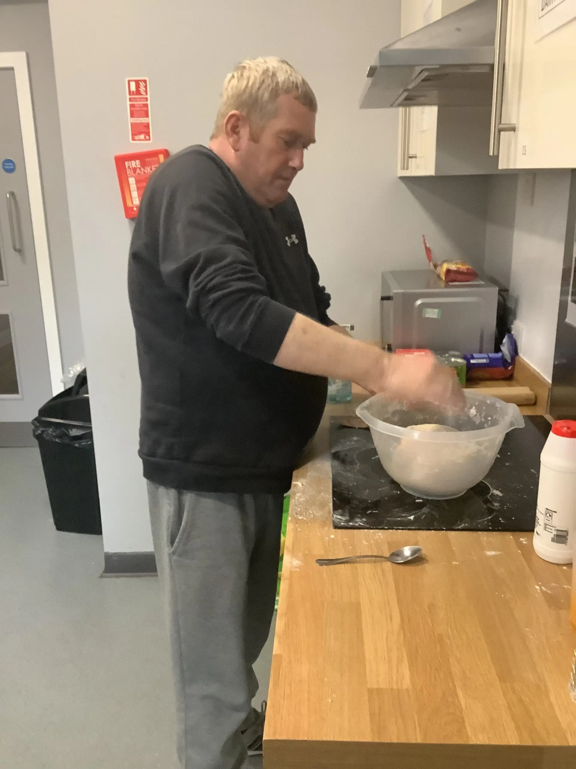 male resident making pizza dough
