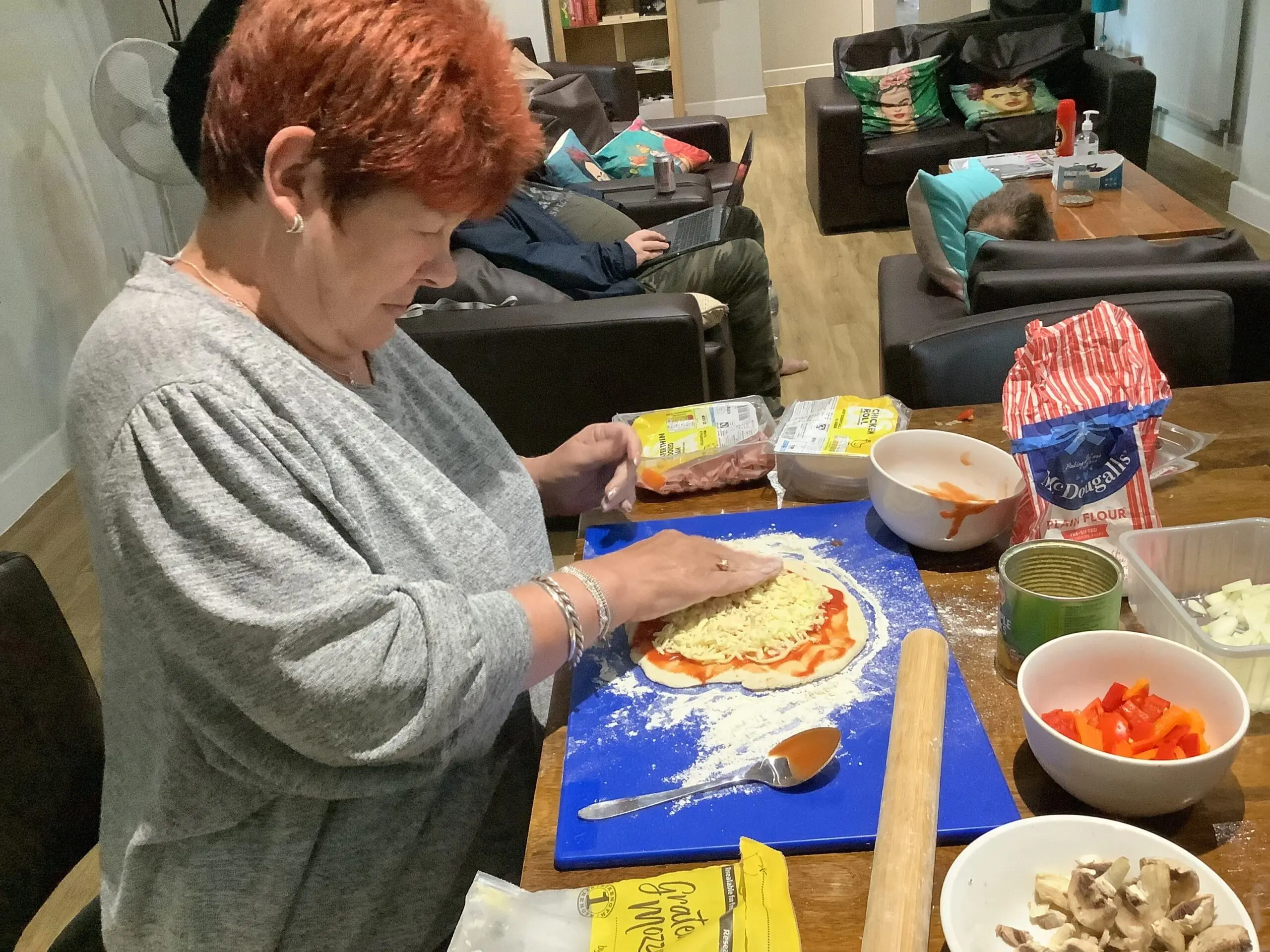 female resident making pizza