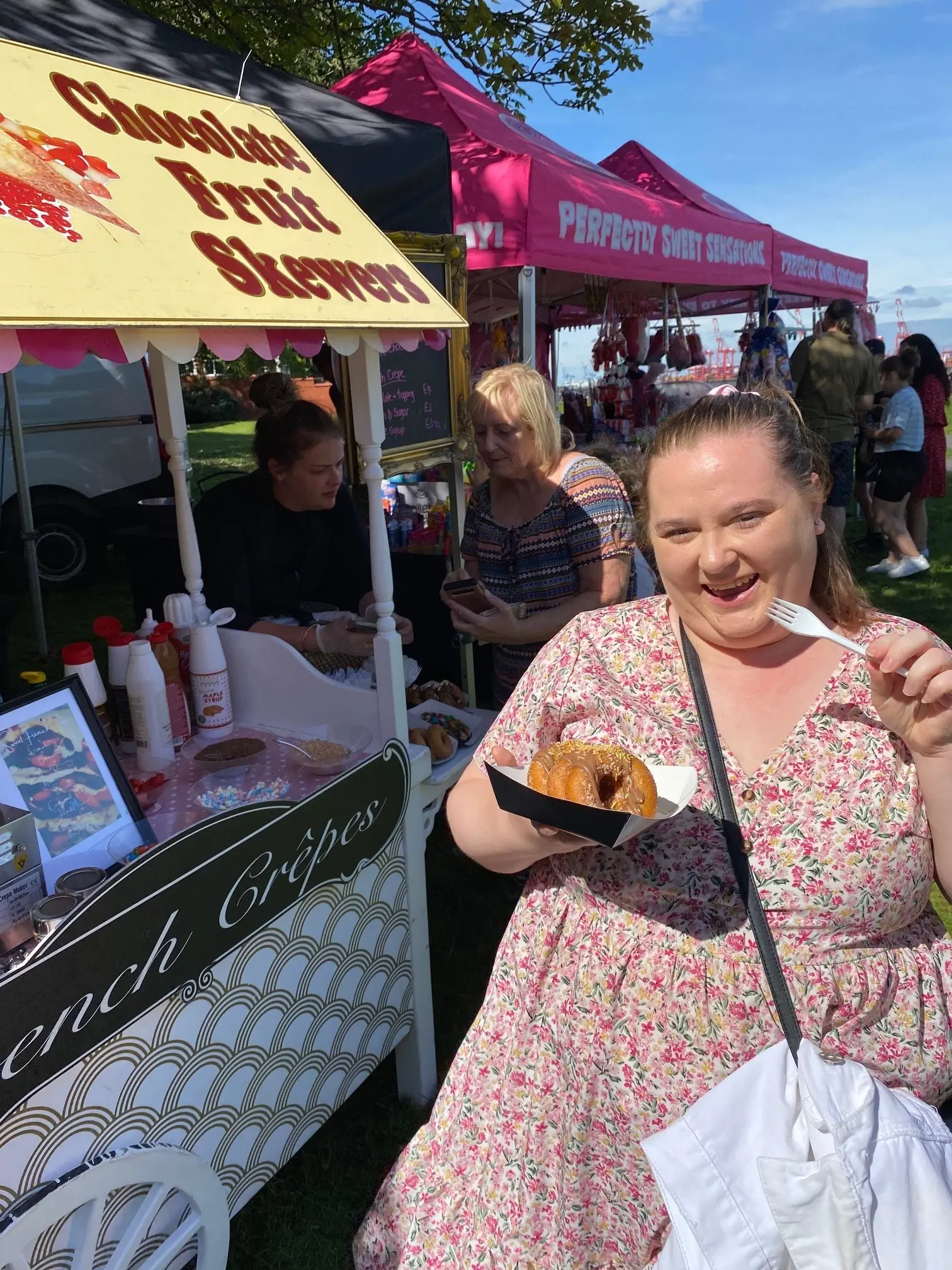 resident enjoying doughnuts from food stall