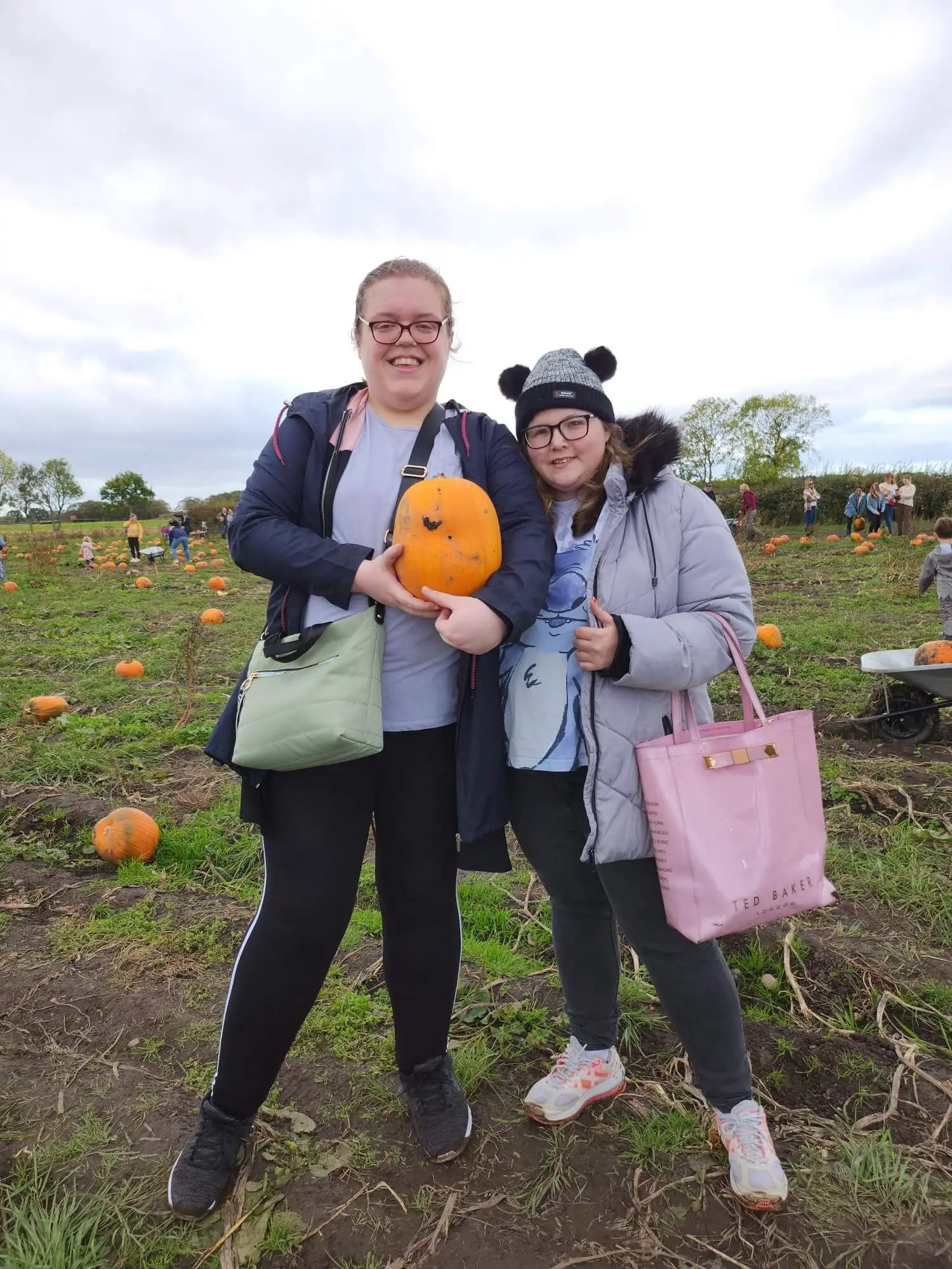 Two residents with a pumpkin