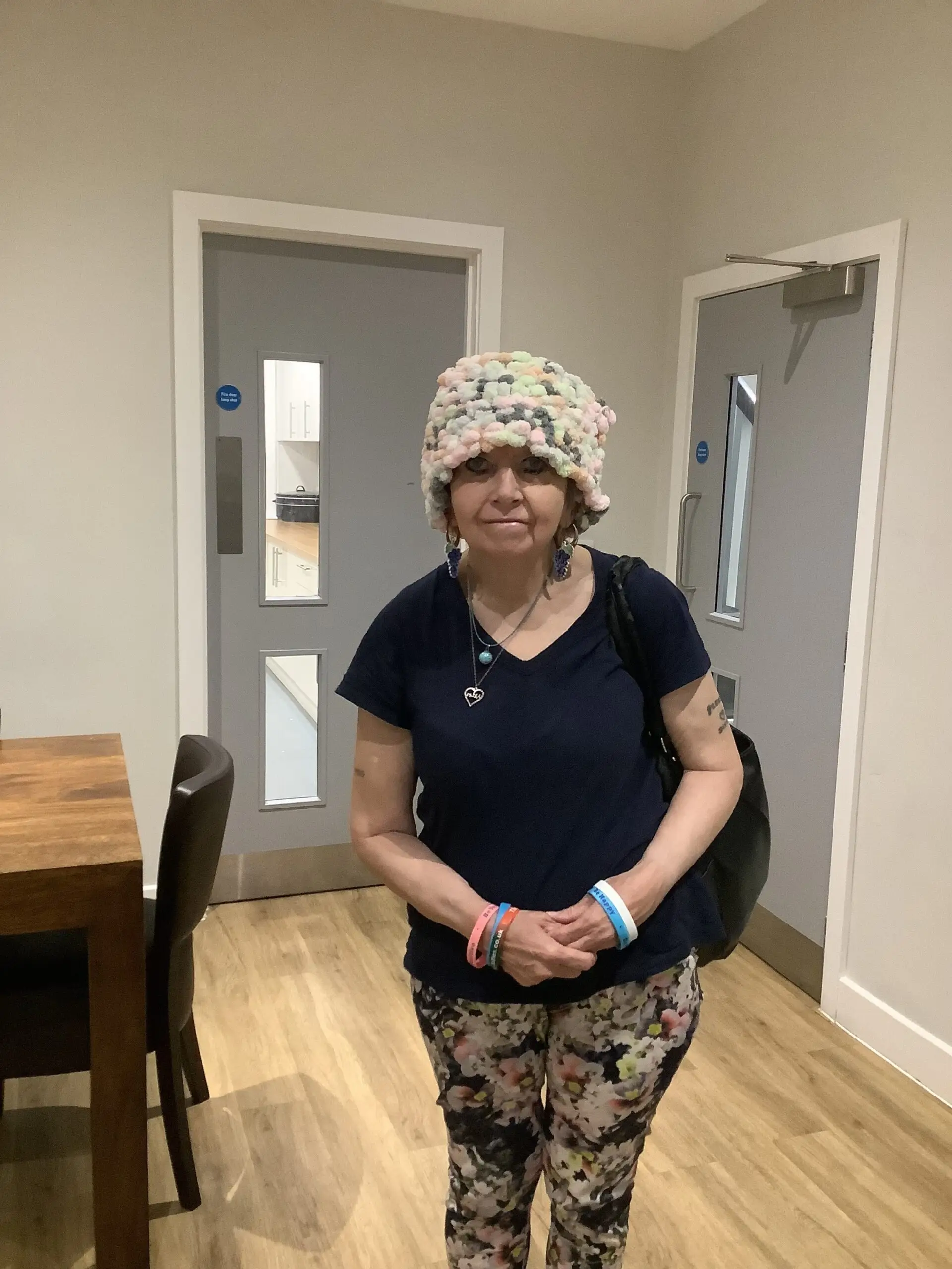 resident wearing a hat that she made
