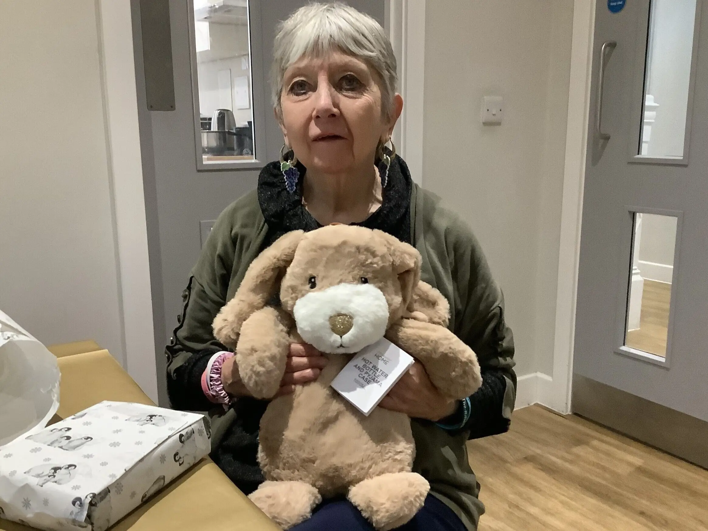 resident posing with a teddy bear