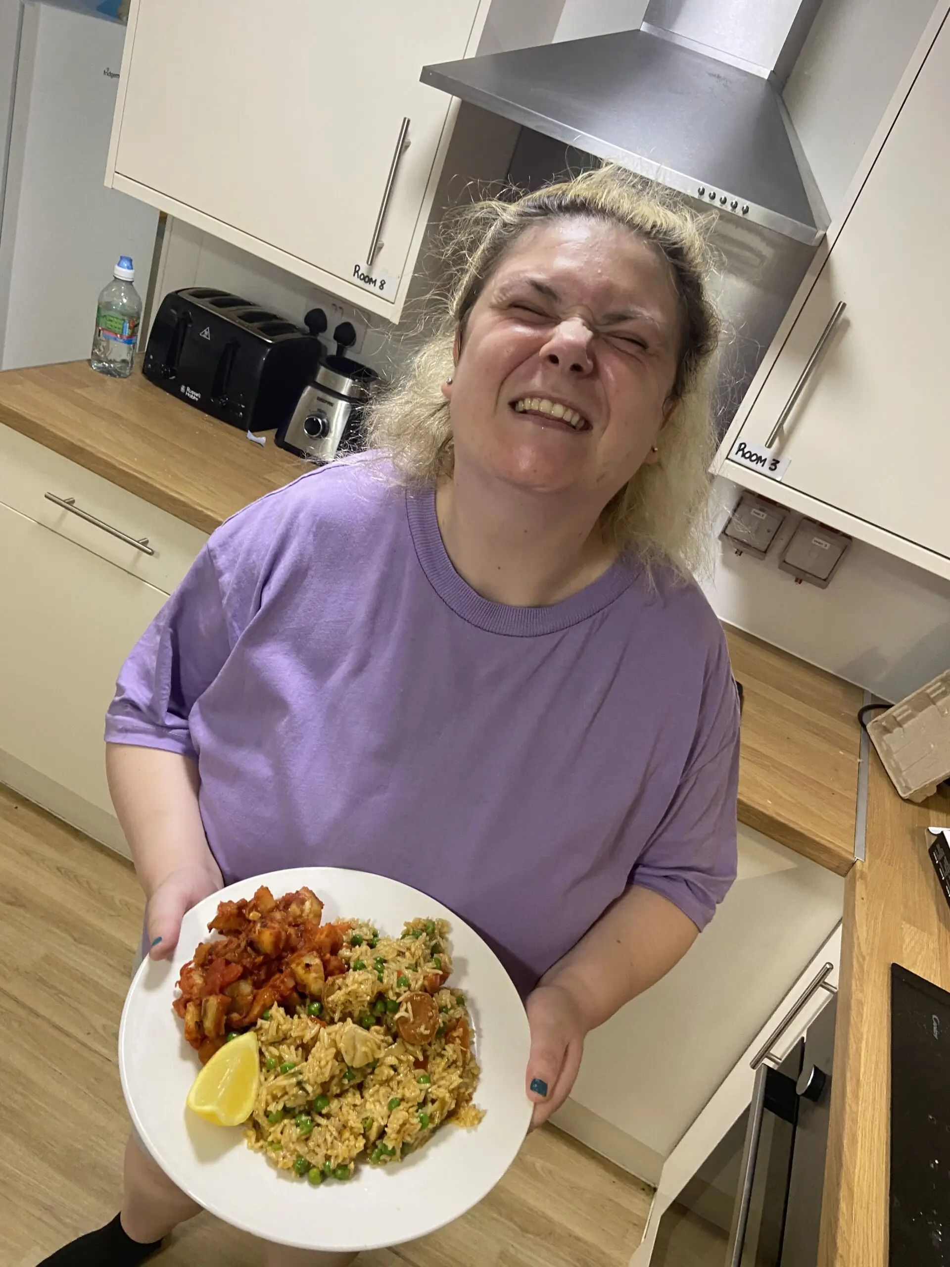resident holding plate of spanish food