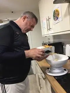 resident pouring flour into measuring bowl