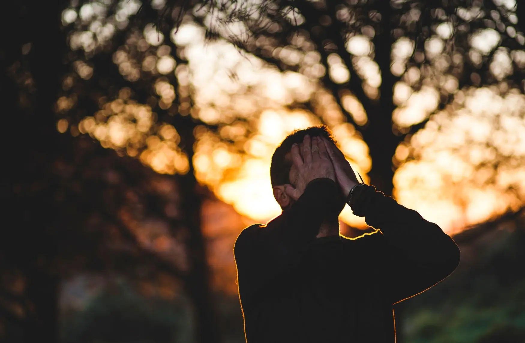 man with head in hands