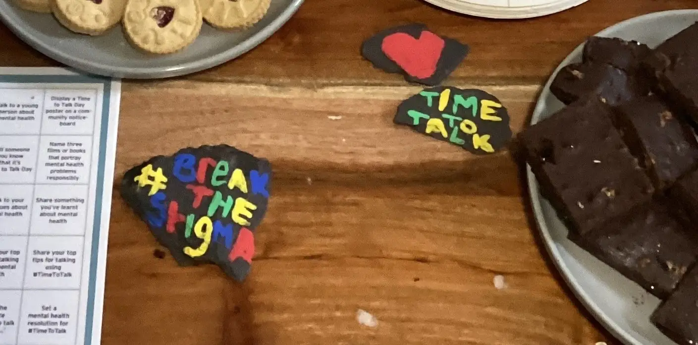 painted rocks that say "time to talk" and "break the stigma"